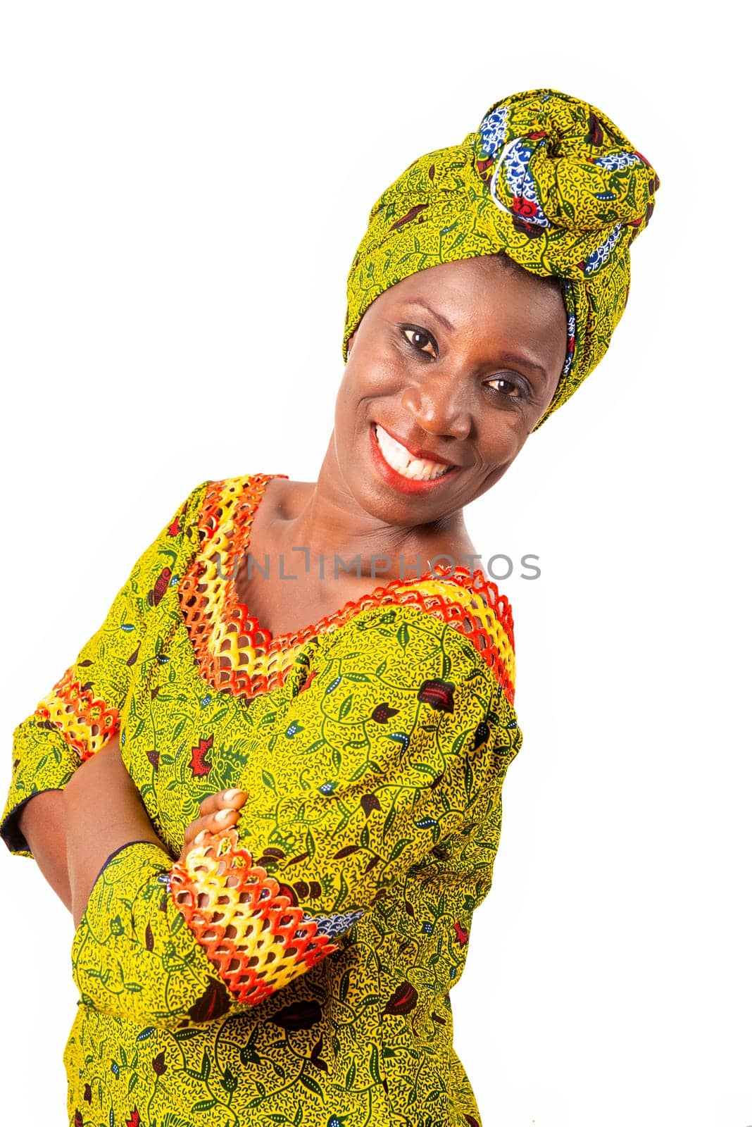 beautiful african adult woman dressed in loincloth and green scarf is smiling sideways crossing arms