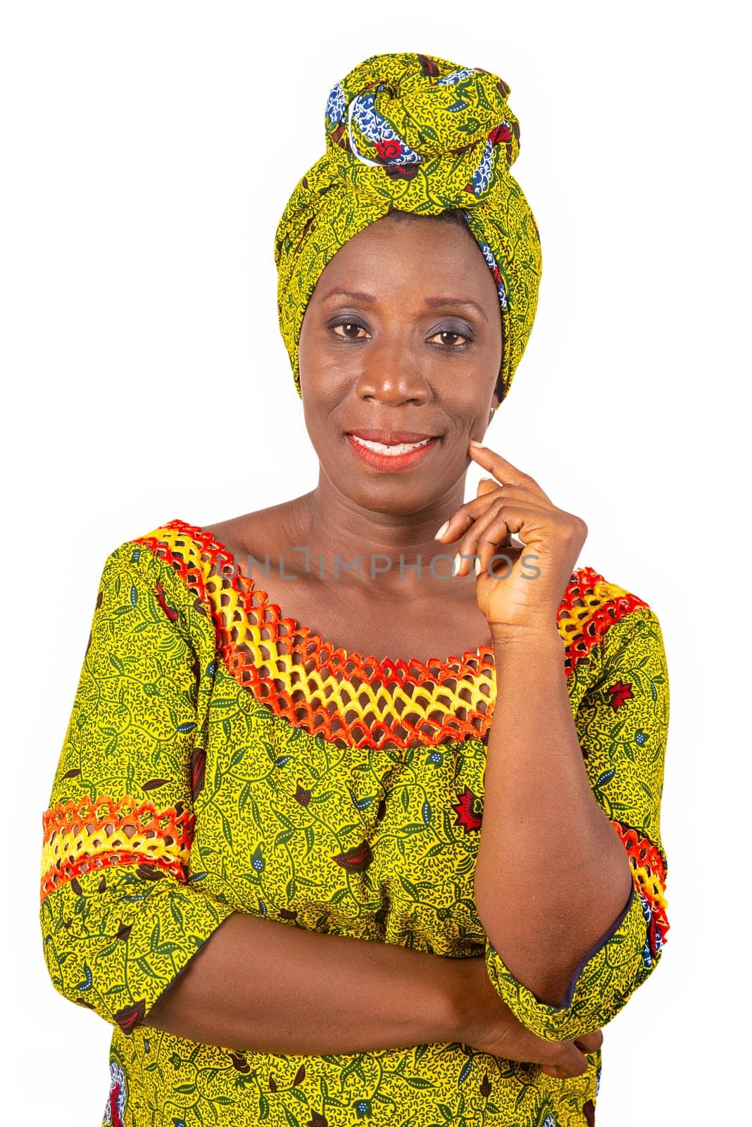 beautiful African adult woman wearing a loincloth and a green scarf is smiling with her arm crossed and her hand on her chin