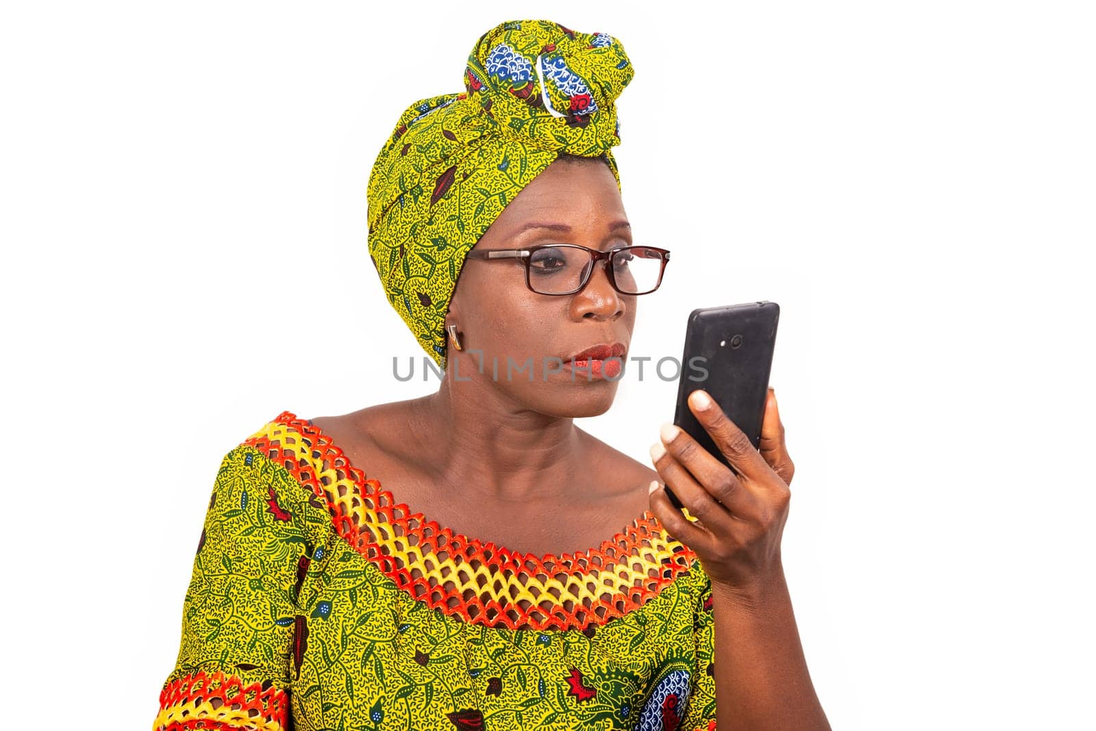 beautiful mature woman in glasses isolated on white background looking at mobile phone.