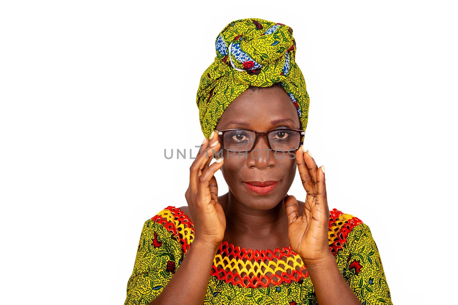 beautiful african adult woman dressed in loincloth and green headscarf wearing beautiful glasses to the eyes is smiling