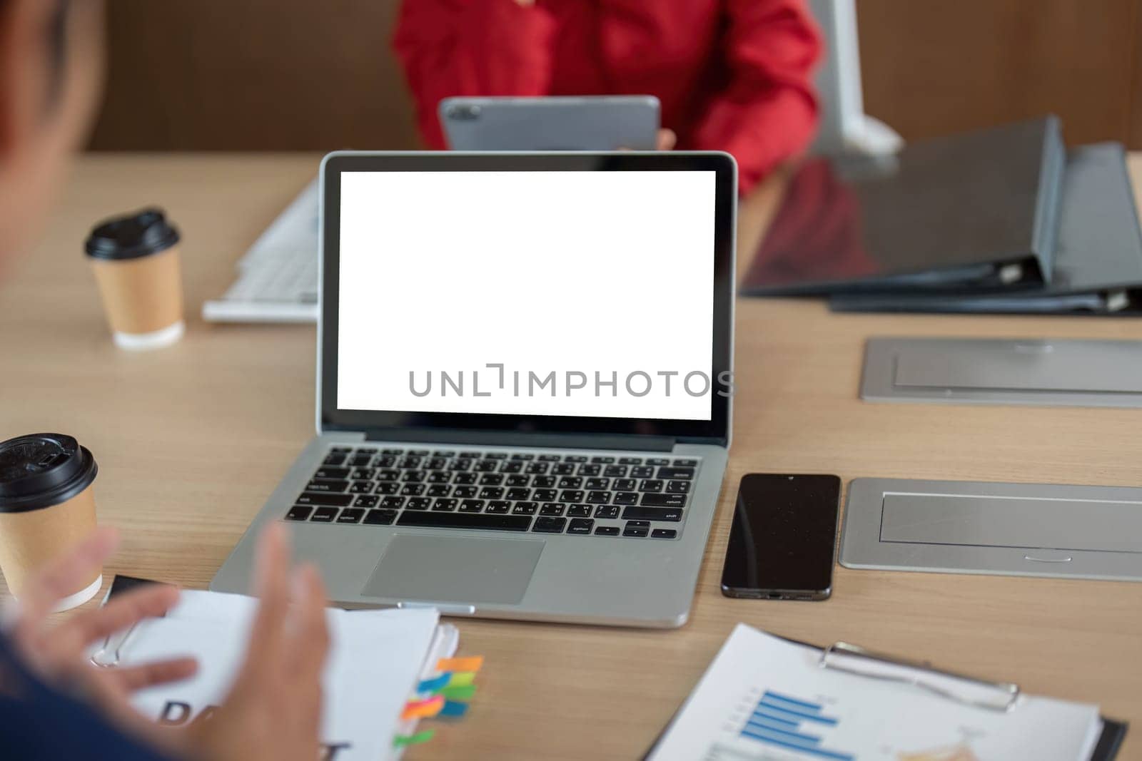 A well-organized office workspace showcases laptops and financial documents, illustrating a productive environment for collaborative work and planning.