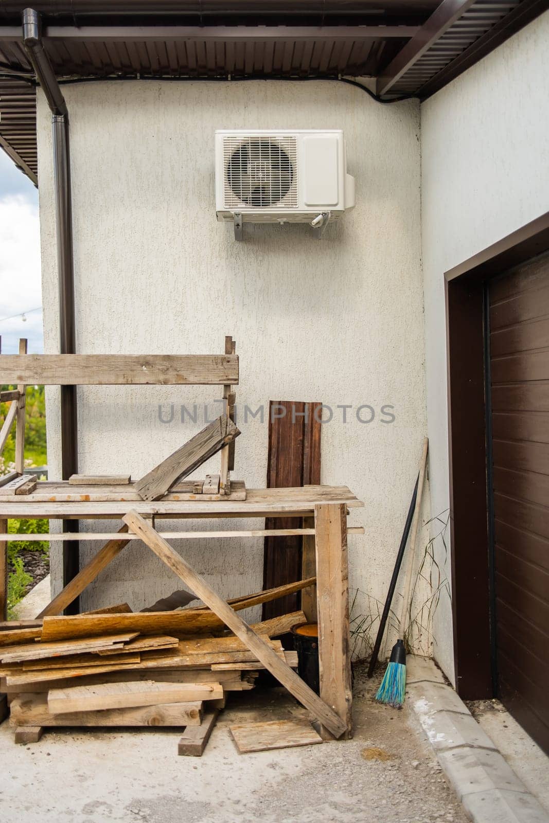 Wooden frames under white air conditioner. Practical home improvement and resourceful construction methods and care.