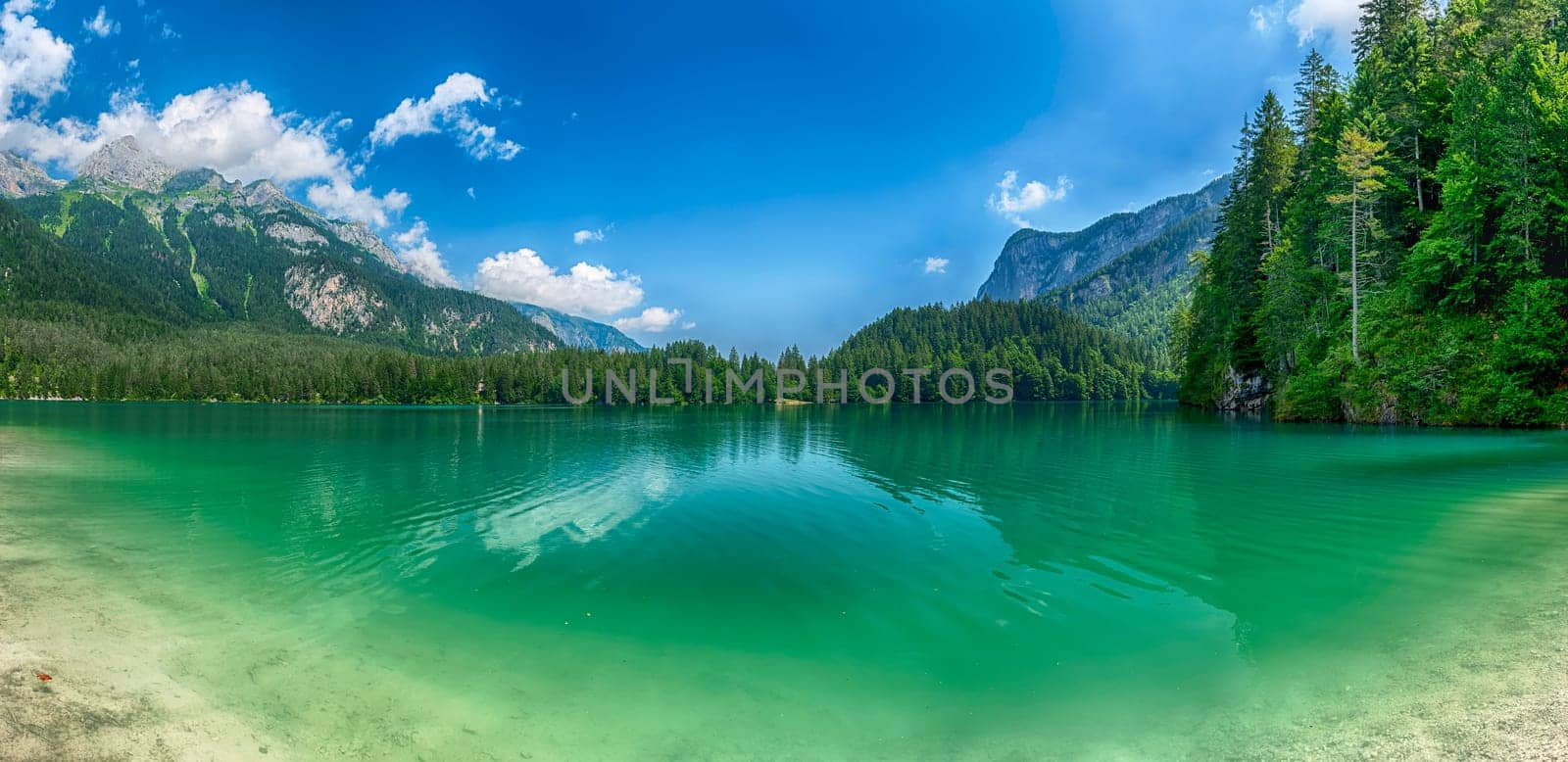 Panoramic view of the beautiful Lake Tovel with the Brenta Dolomites in the background on a sunny summer day, Trentino Alto Adige, Italy