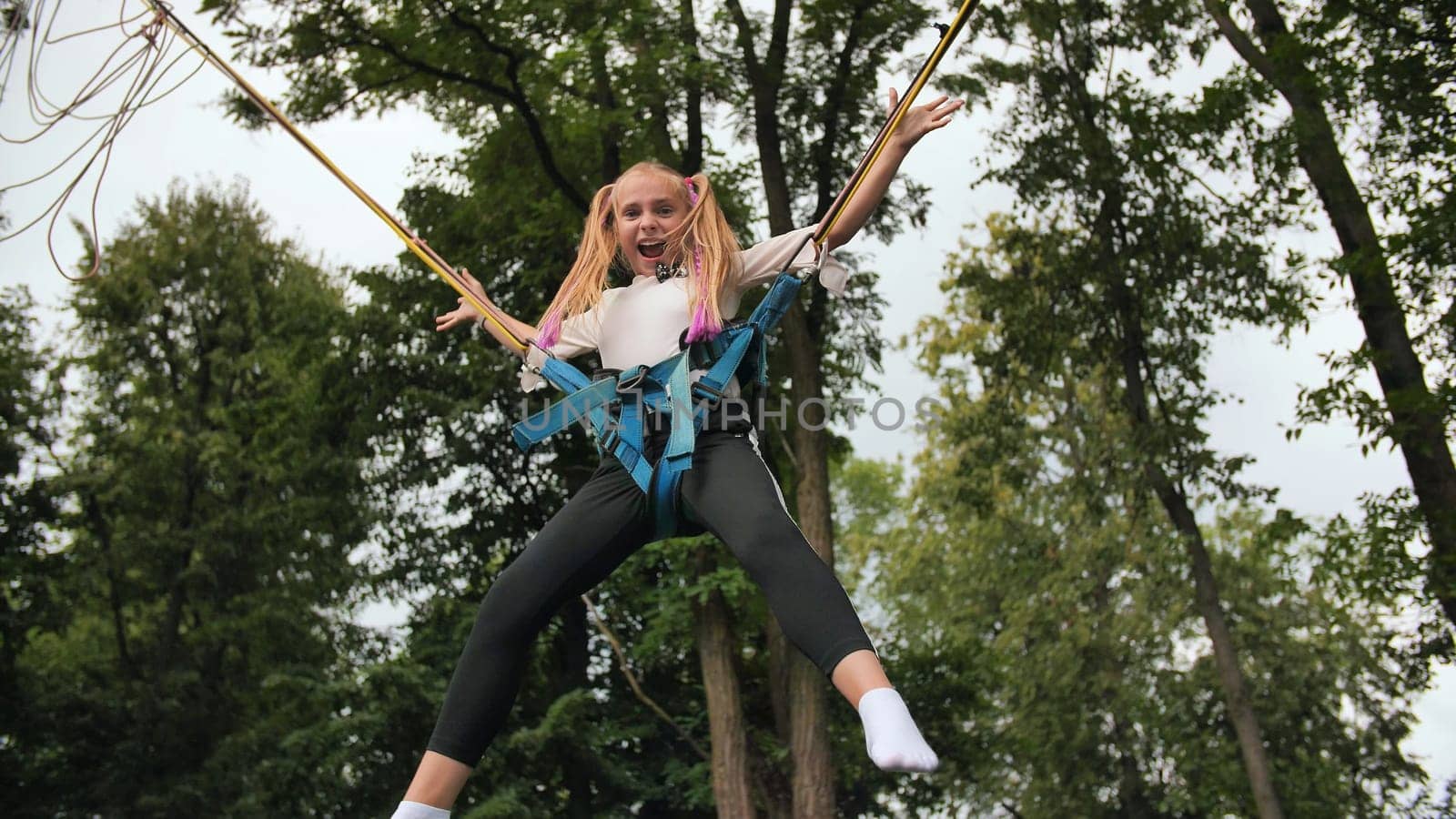 Teenage girl jumping on the trampoline bungee