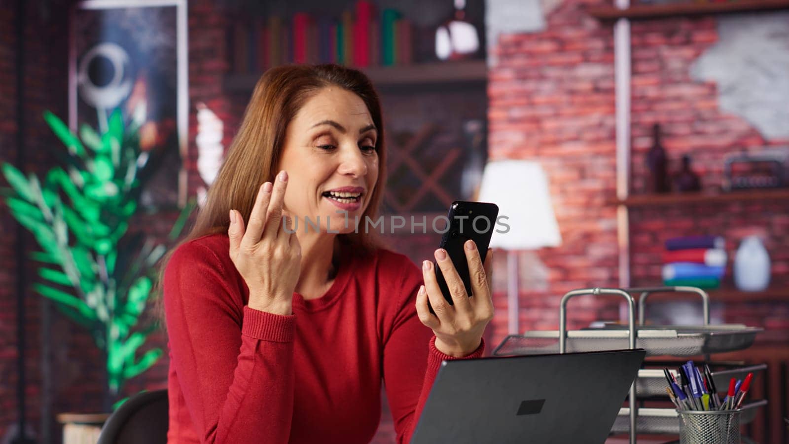 Mature woman engaging in virtual workshop to learn new skills for job, interacting with the coach. Ambitious person joining interactive web learning session for personal development. Camera A.