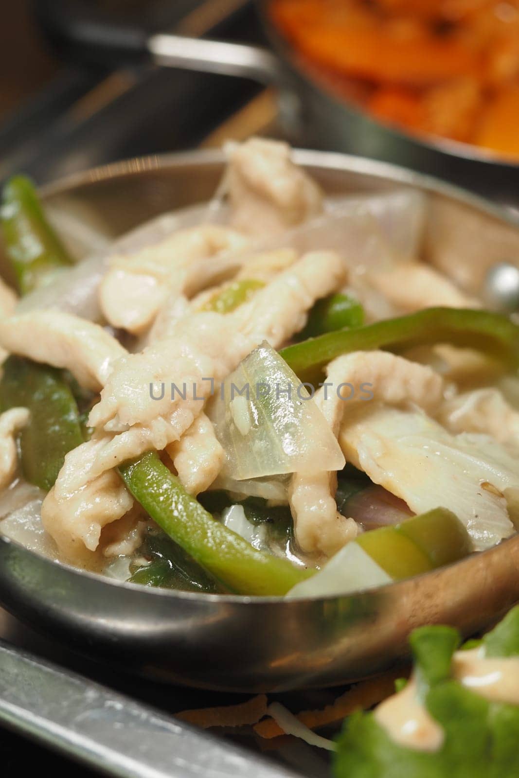 A delicious chicken stir-fry featuring bell peppers and onions on display.
