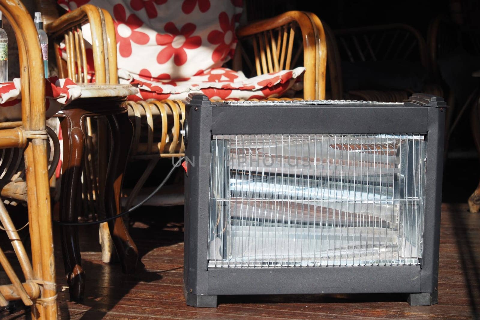 A small heater warms the space in a cozy setting with floral decor.