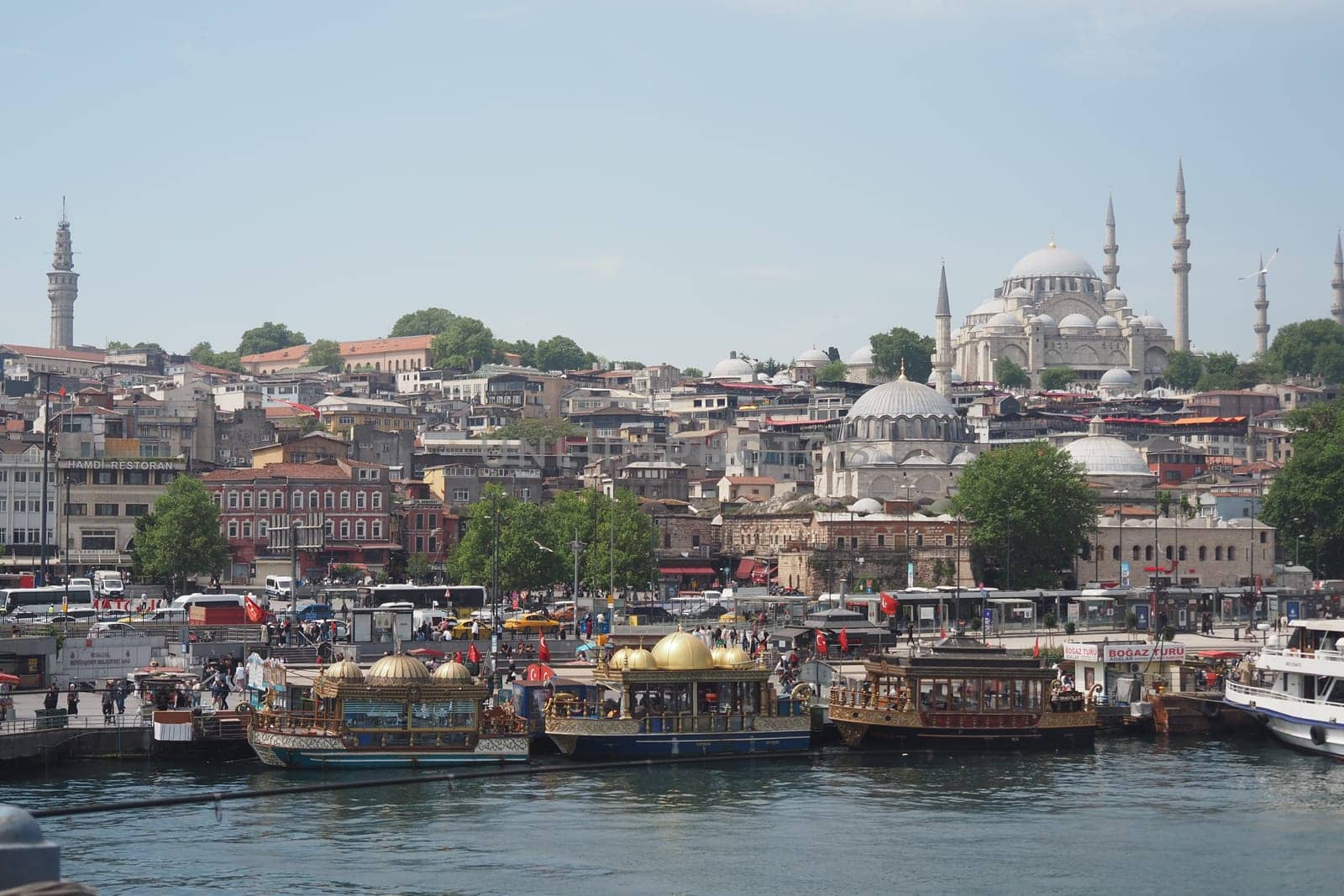 Colorful boats are moored at the docks near Istanbul, showcasing the skyline.