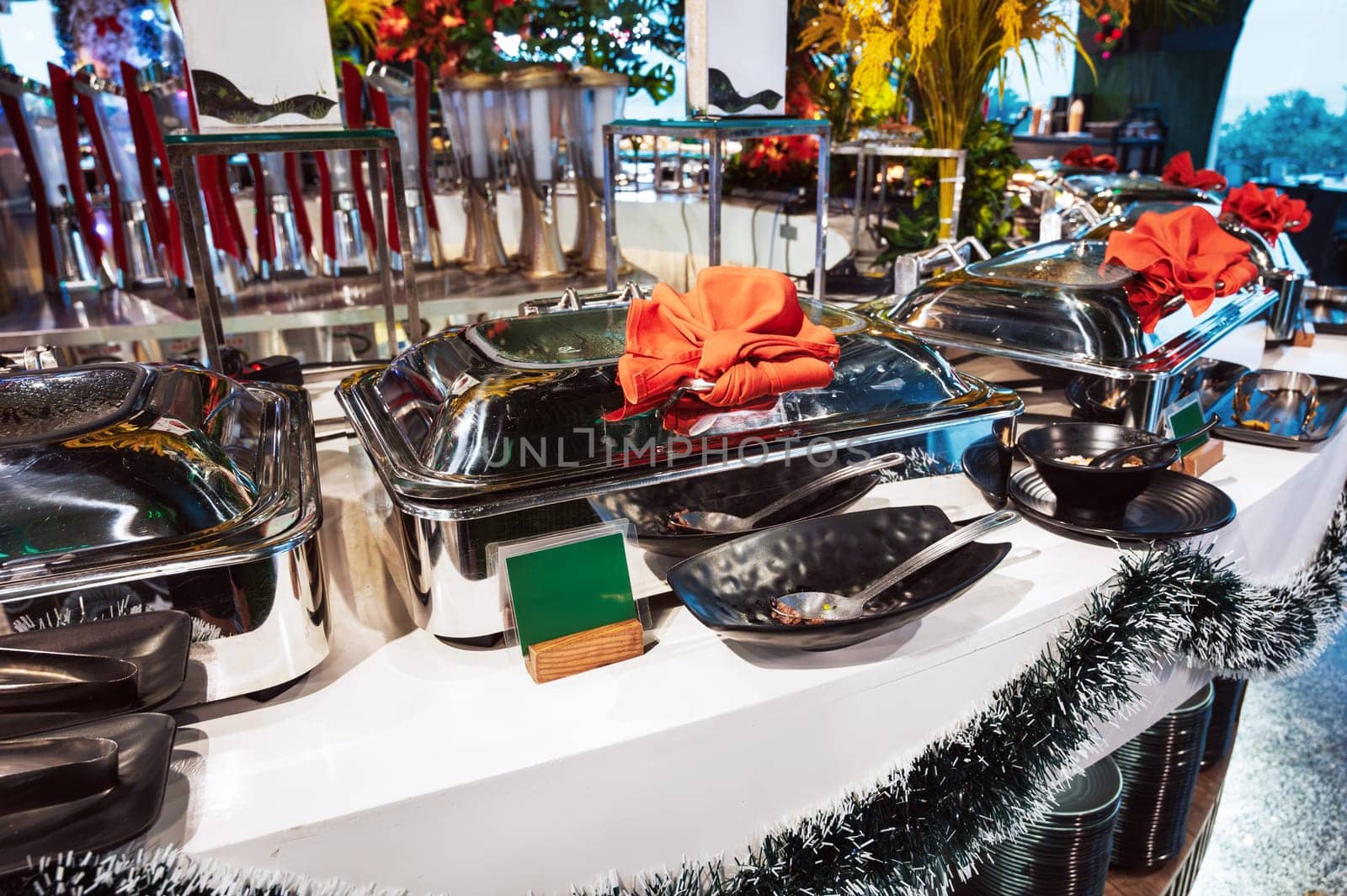 hot dishes in trays on the buffet table in the self-service restaurant at the hotel in the resort