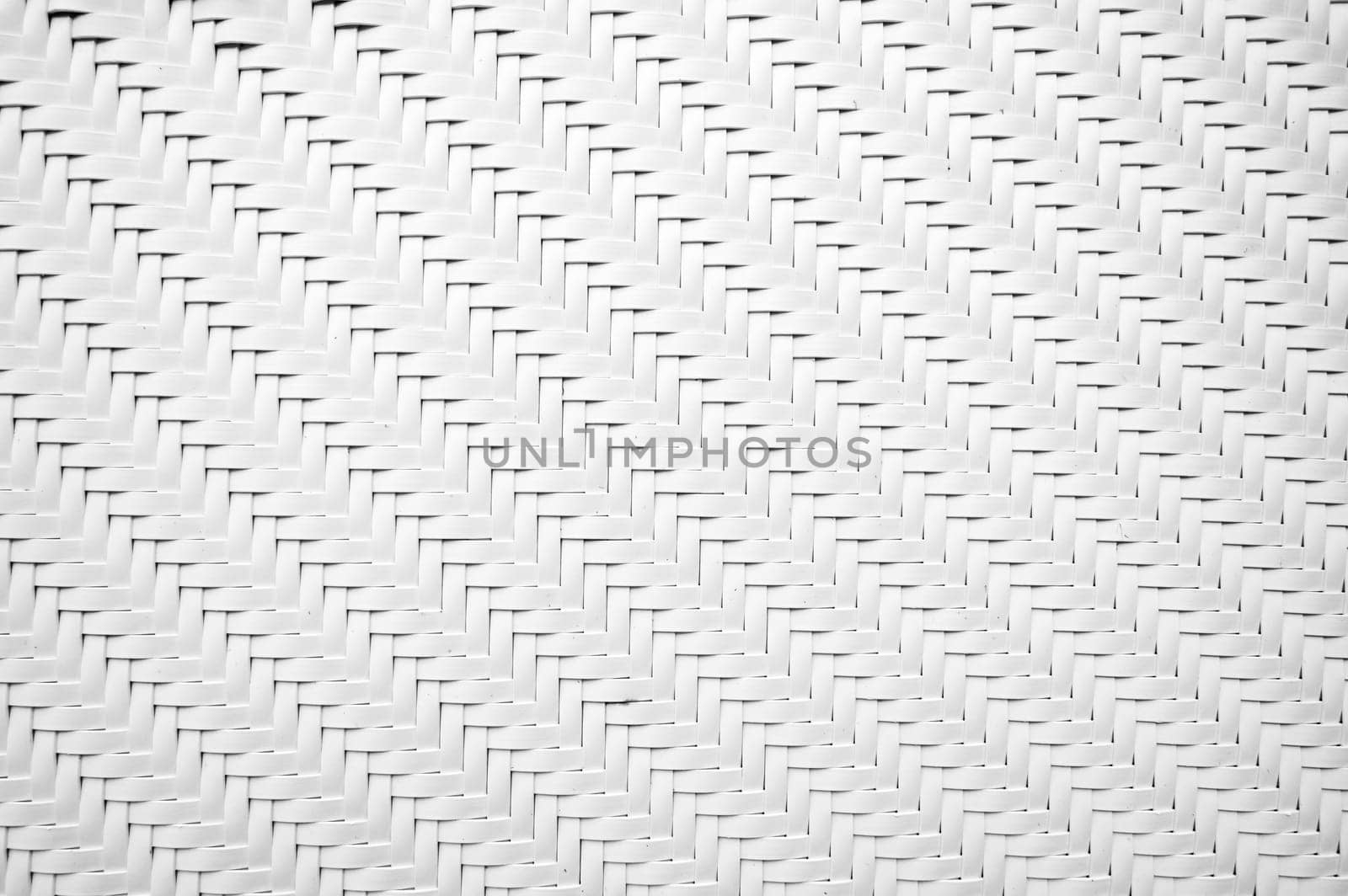 white background with artificial texture of woven rattan. Abstract braided plastic pattern