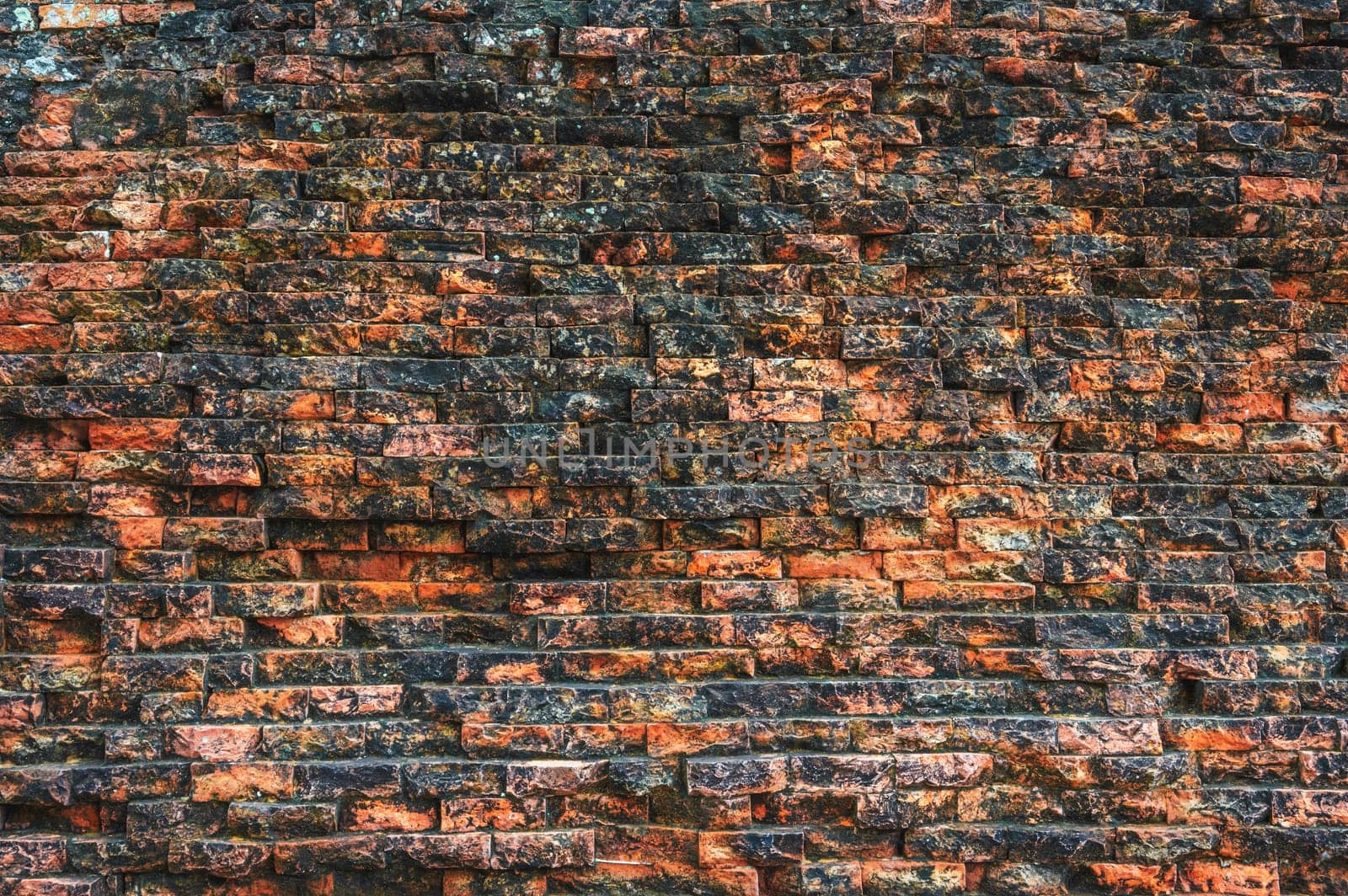 texture of an ancient old historical brick wall. Vintage background with weathered structure