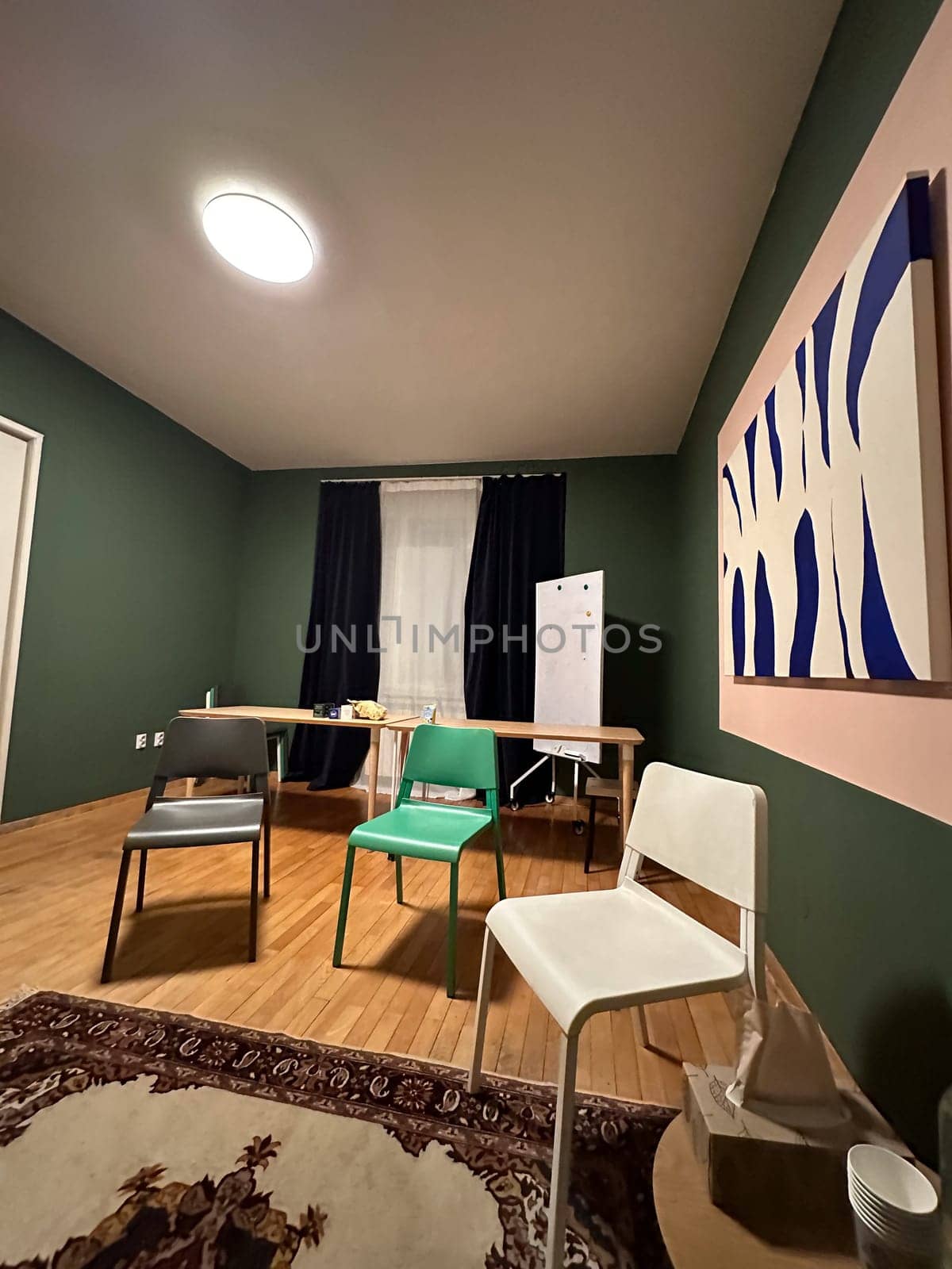Modern group therapy room with chairs and whiteboard prepared for session. Psychological support and safe communicative space.