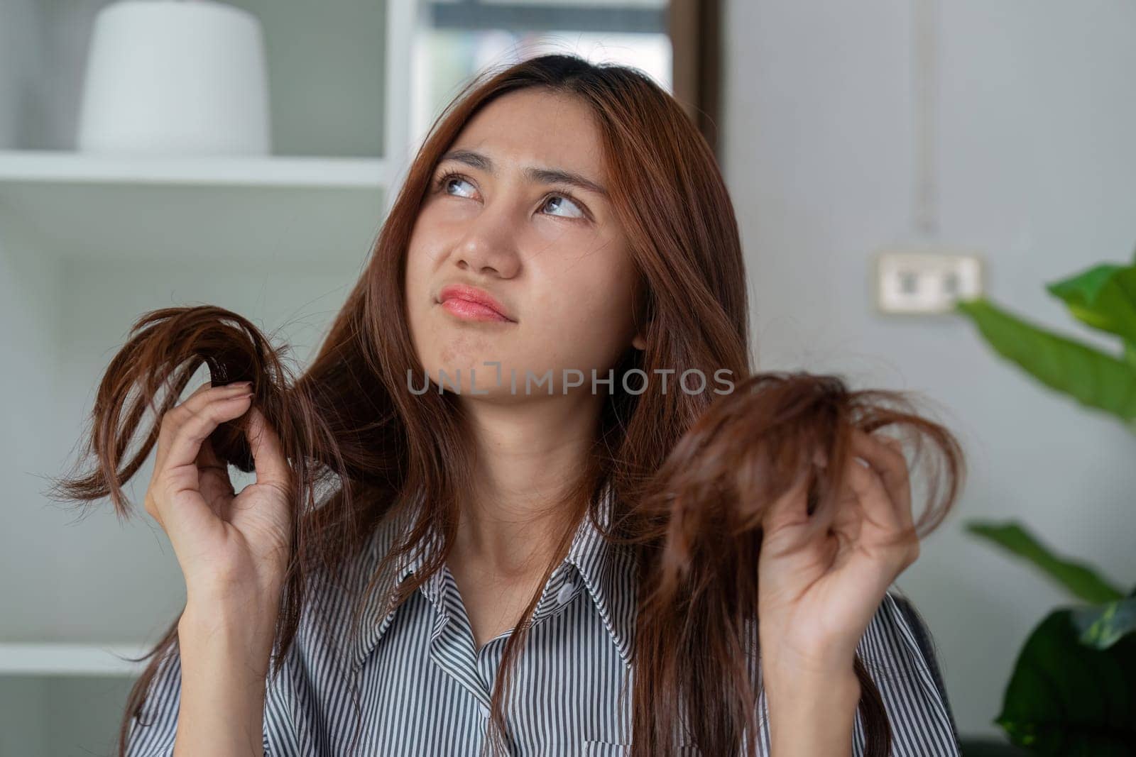 Faced with hair styling challenges, a woman explores ways to manage her unruly hair, reflecting on practical haircare techniques.