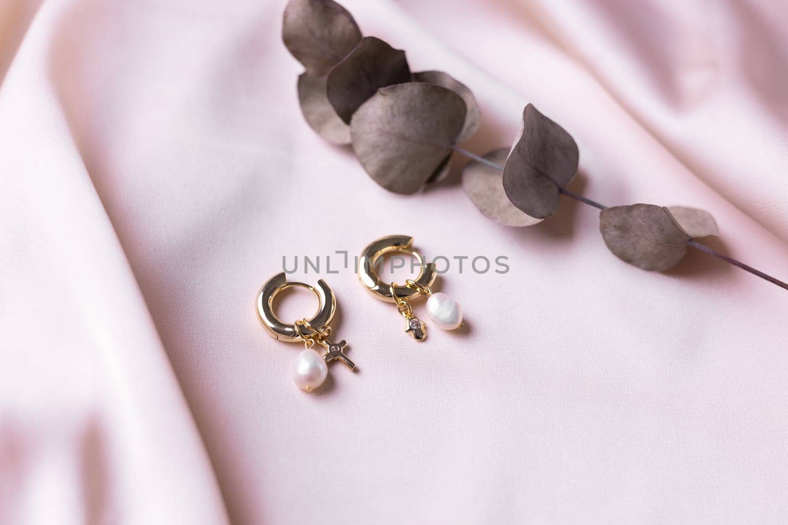 Women's Jewelry. Trendy jewelry on silk background. Flat lay, top view