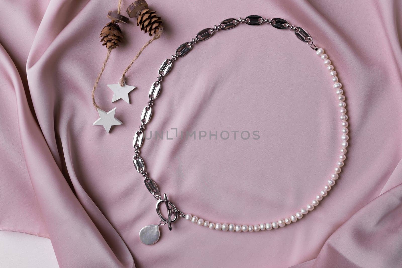 Women's Jewelry. Trendy jewelry on silk background. Flat lay, top view