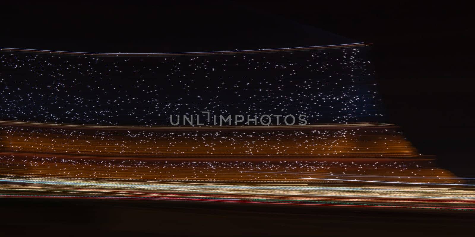 Paris, France - February 24, 2025: the view of illuminated Eiffel Tower at night as streaks of light fill the scene, captured in motion with long exposure. Creative dynamic romantic background