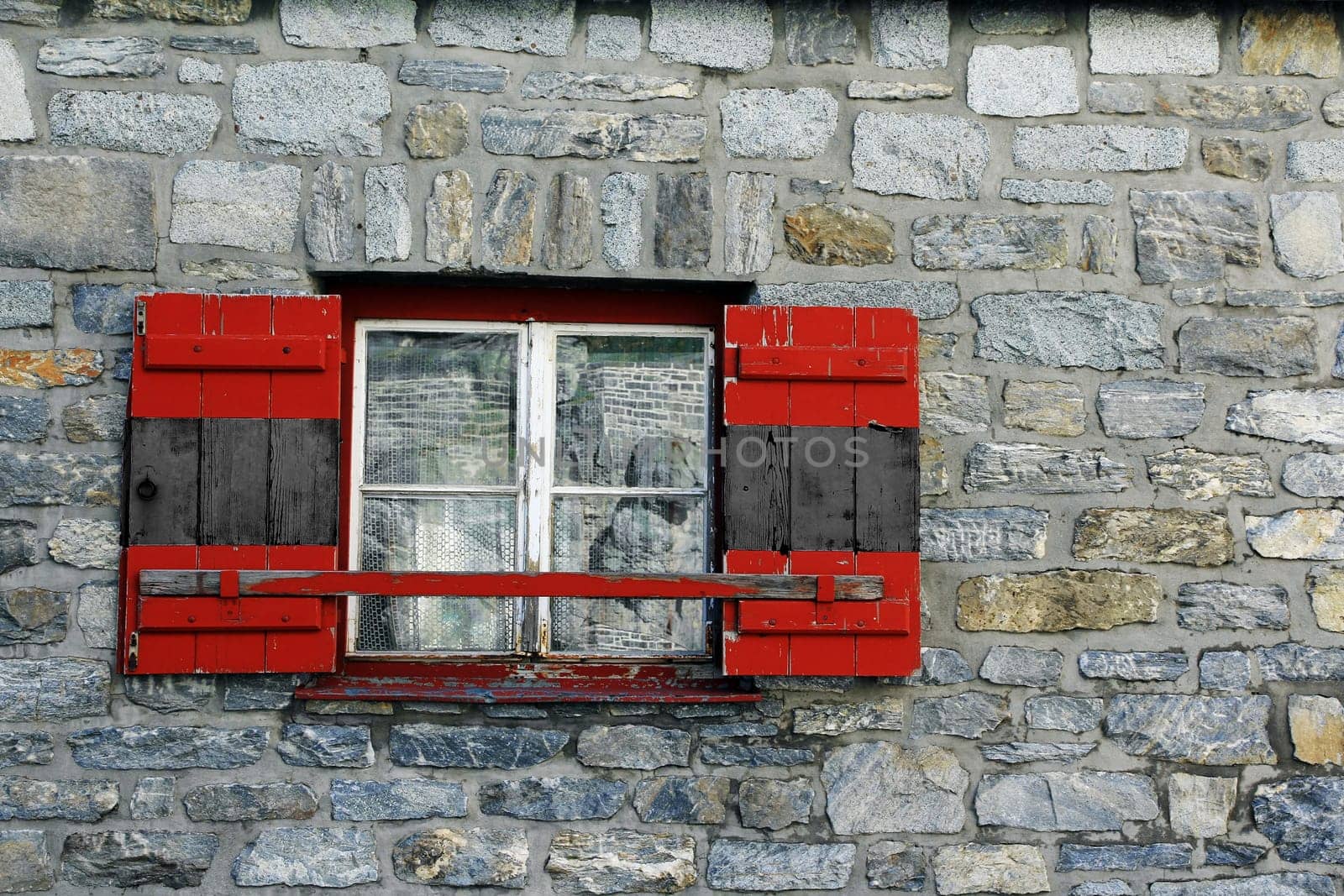 Old window with black and red shutters. Symbolic photo for a Groko in Germany