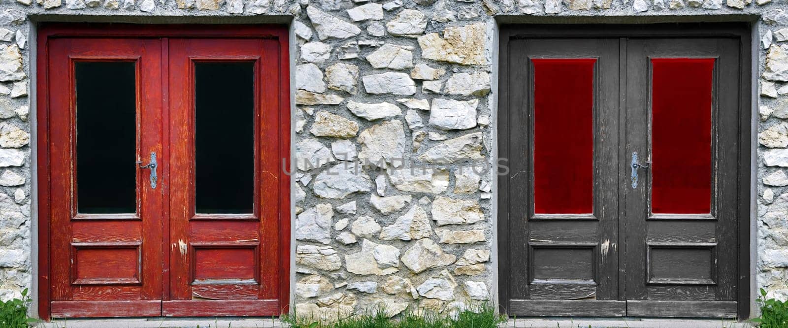 Old door on a stone house in red and black. Also a symbolic photo for a Groko in Germany