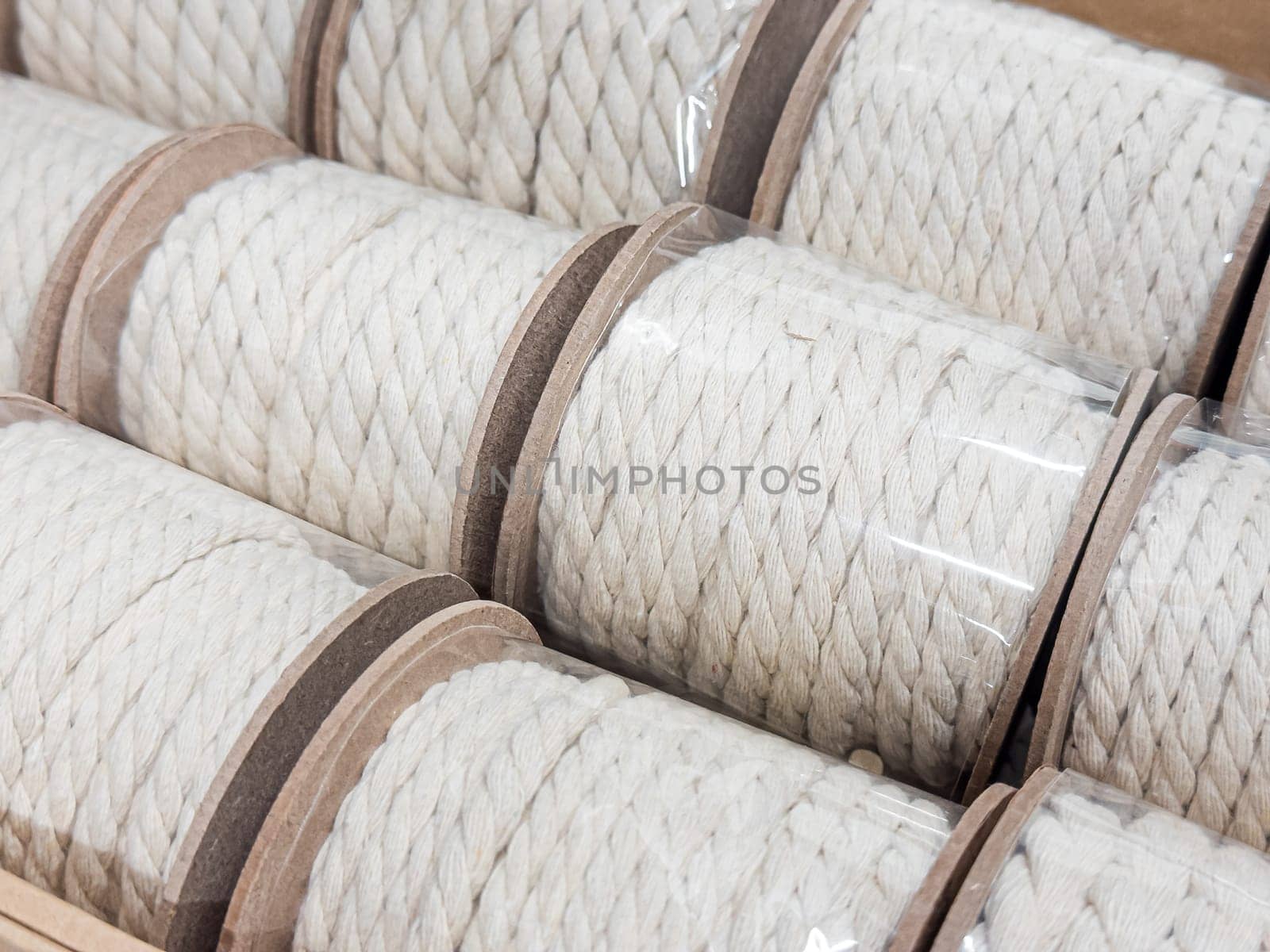 Close up of rolled white cotton rope in cardboard packaging.