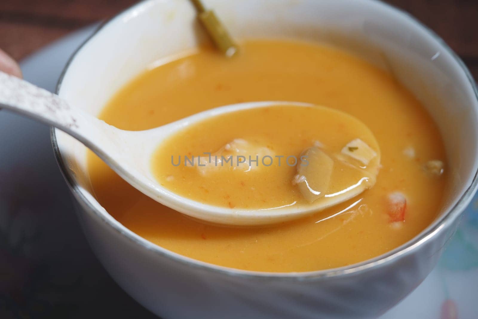 Delicious seafood soup being enjoyed with a spoon at home.