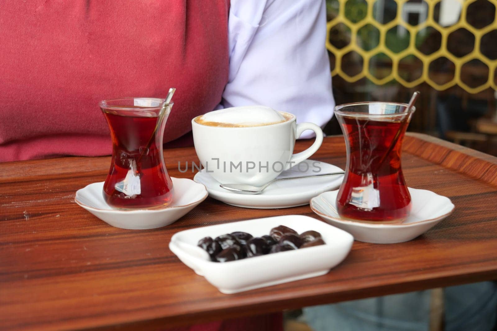 turkish tea served on a wooden tray in a cozy cafe.