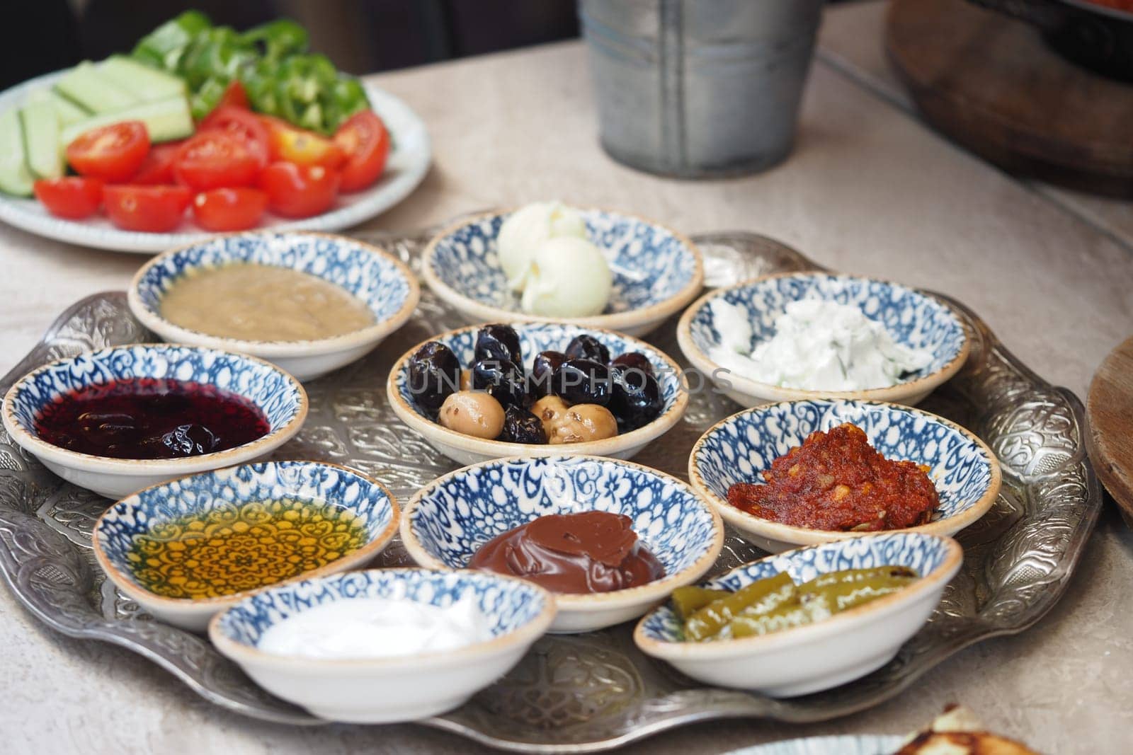 Assorted sauces and dips displayed on a tray with fresh vegetables.