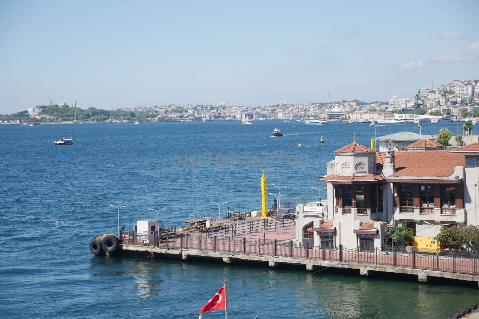A vibrant coastal view of Istanbul featuring boats and skyline scenery.