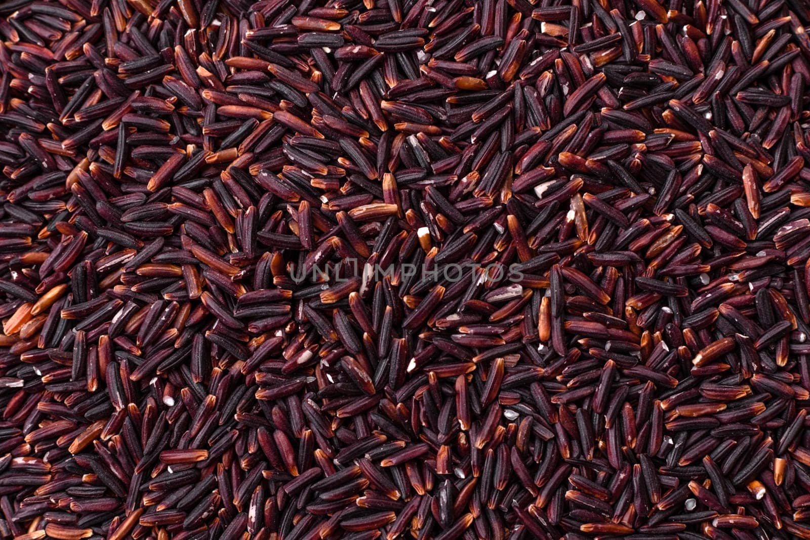 Red or brown raw rice in a ceramic bowl. Rice as an ingredient in Asian organic food