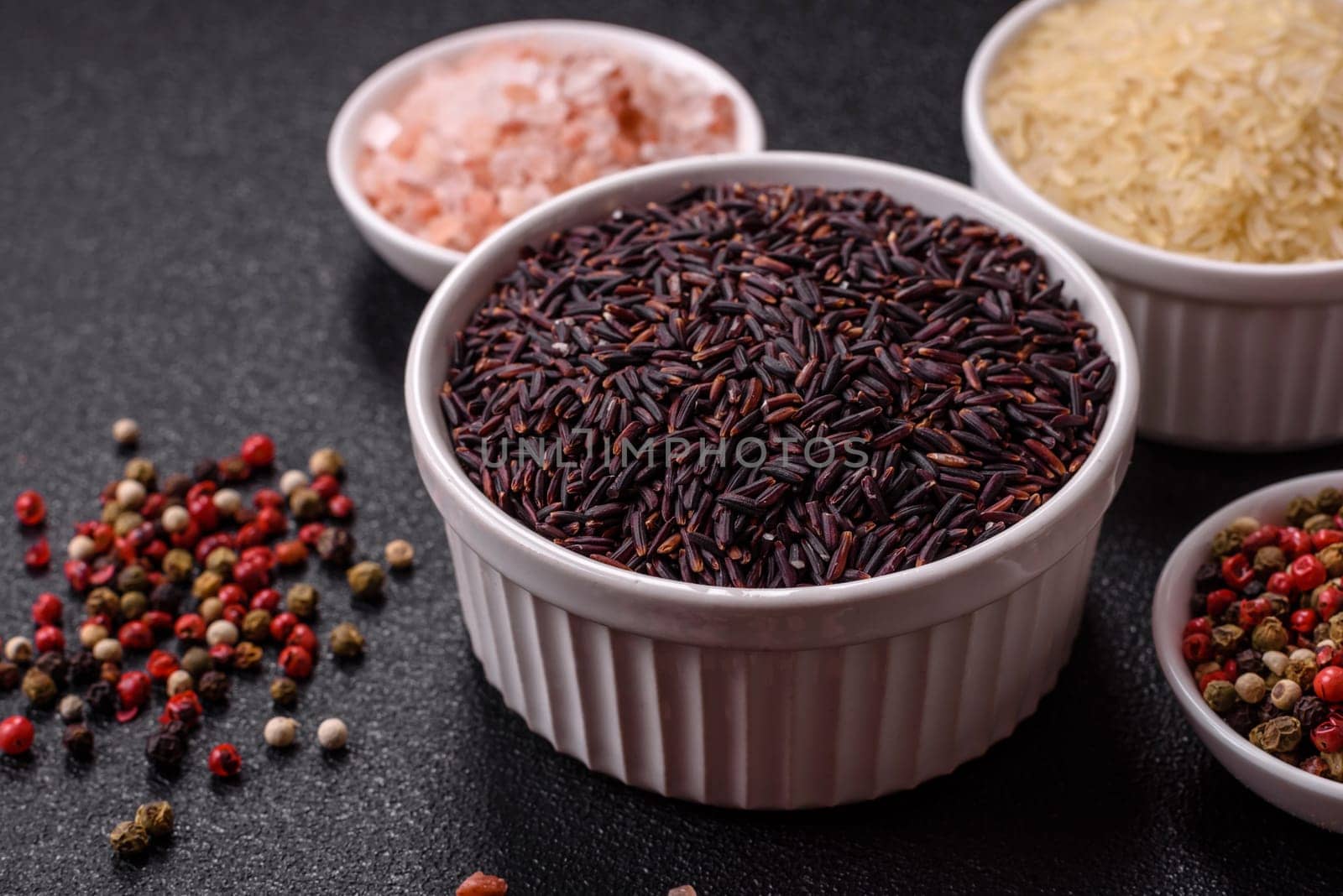 Red or brown raw rice in a ceramic bowl. Rice as an ingredient in Asian organic food