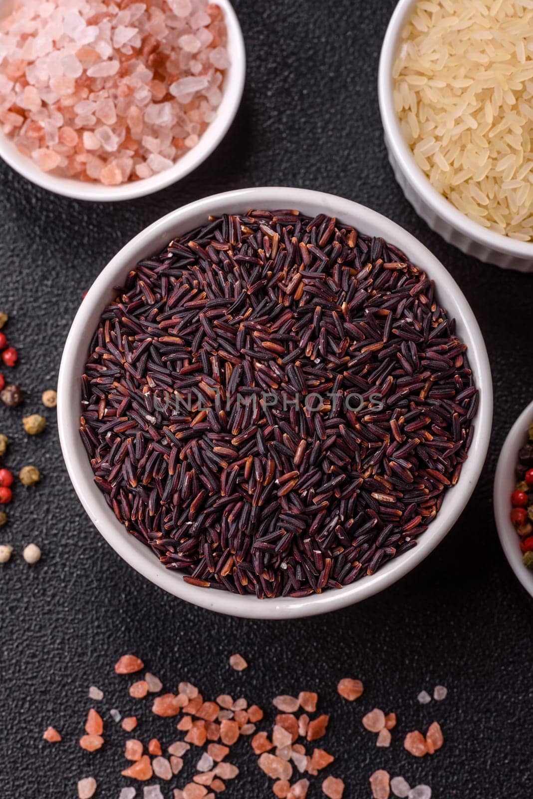 Red or brown raw rice in a ceramic bowl. Rice as an ingredient in Asian organic food
