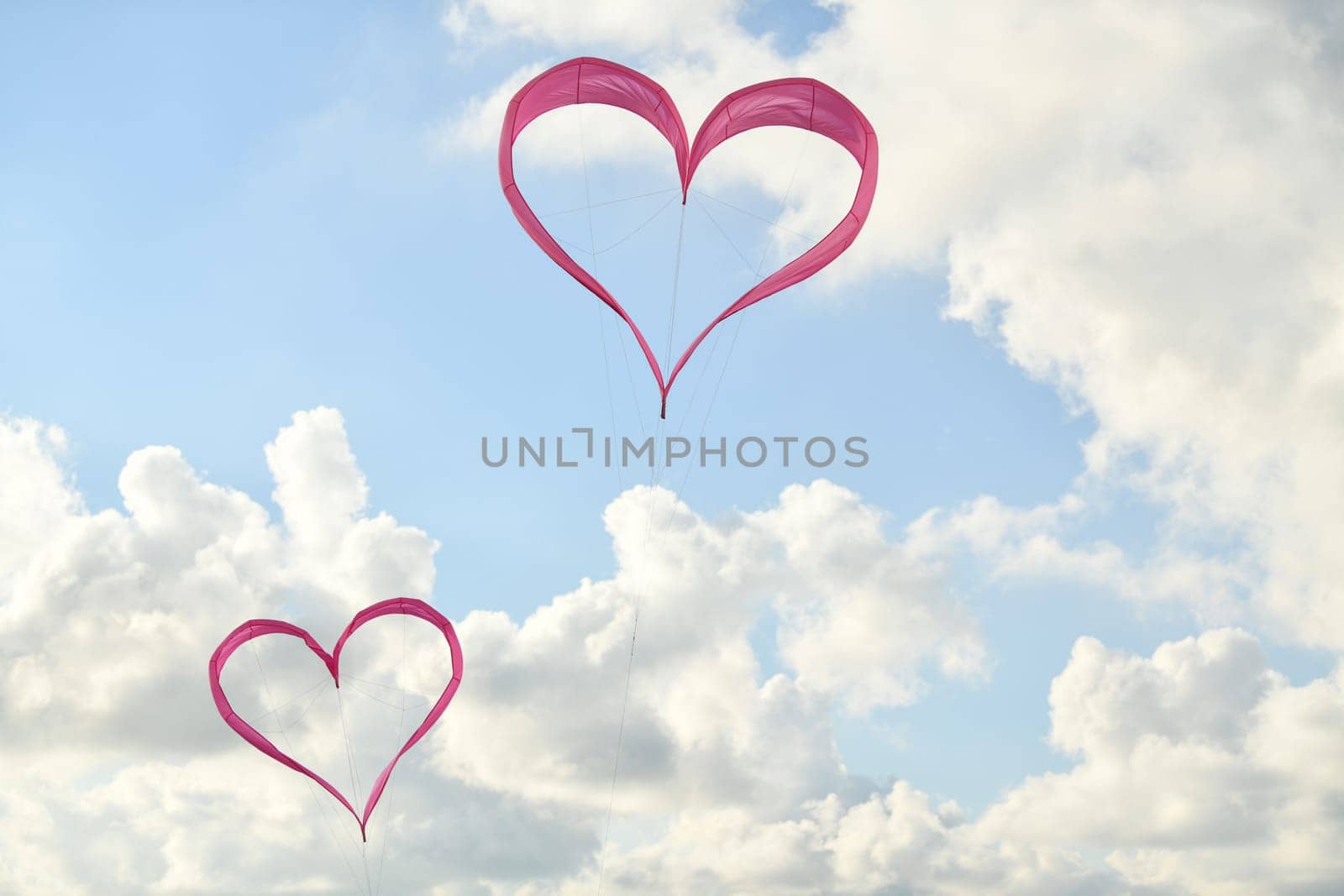 Pink hearts kites is flying in the sky