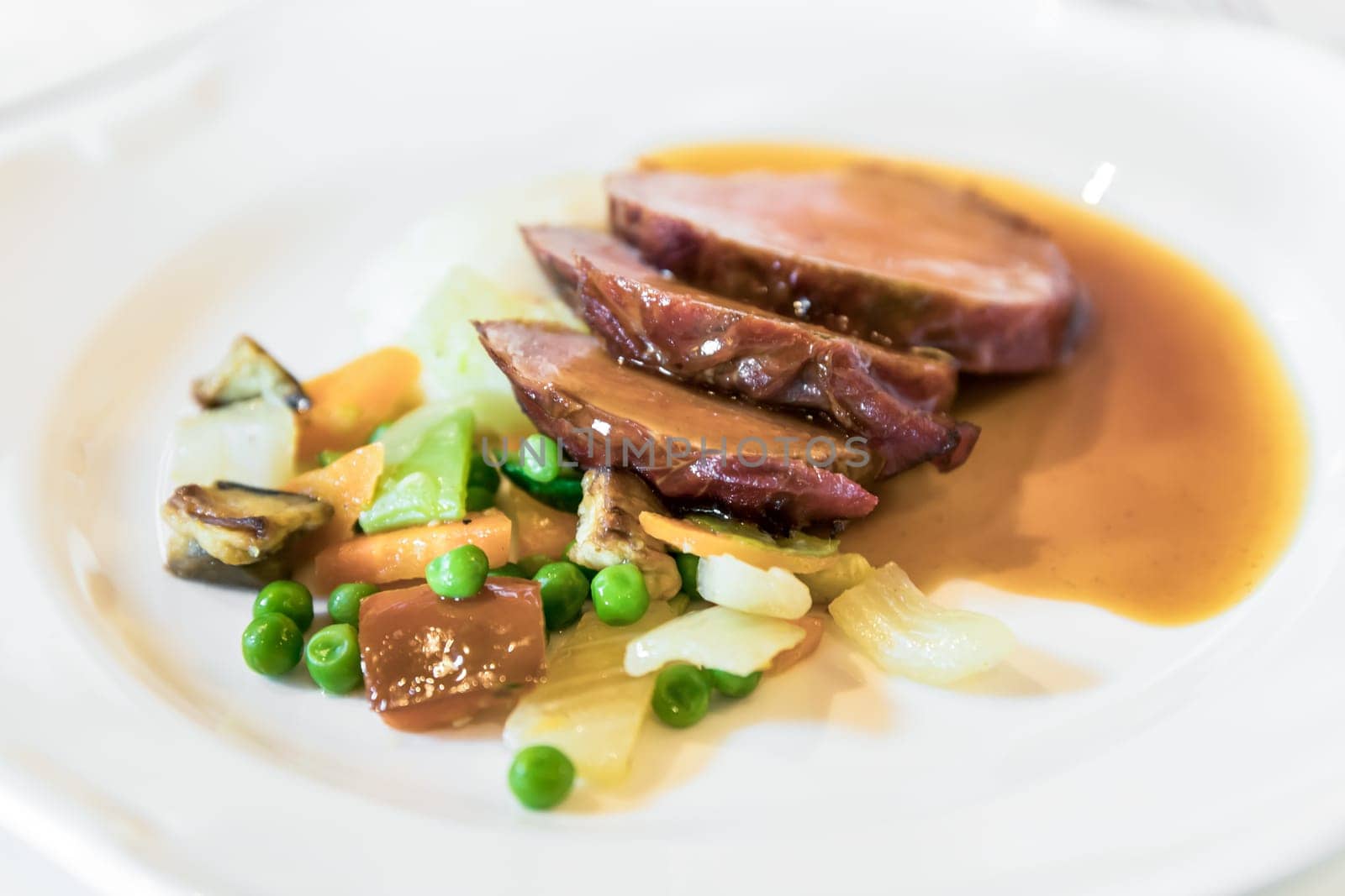Roast with side dish of vegetables. Braised beef. Served for event, or wedding. Fine meat.