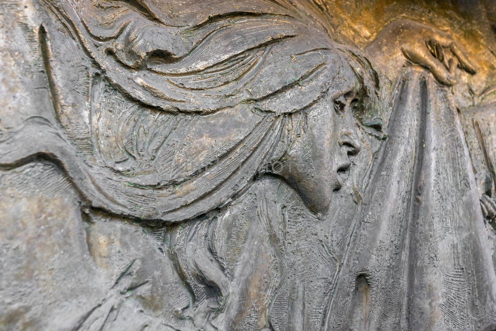 Bas-relief face of a suffering woman. Backgrounds and concepts.