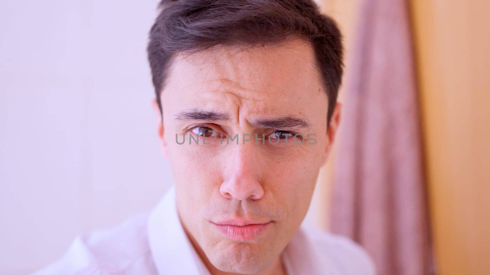Self assured and confident man looking at himself in the mirror