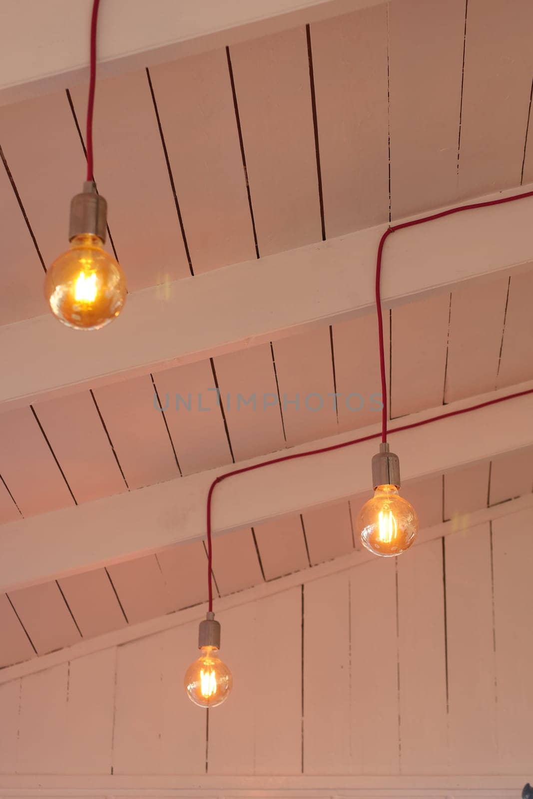 Soft warm light emanates from vintage bulbs suspended from the ceiling.