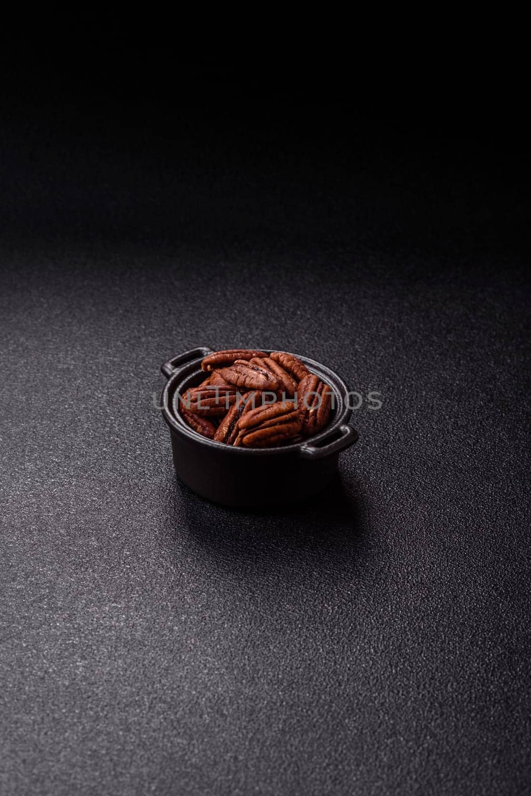 Nut, pecans in a ceramic bowl, an ingredient in vegan food. Nuts as a source of nutrients