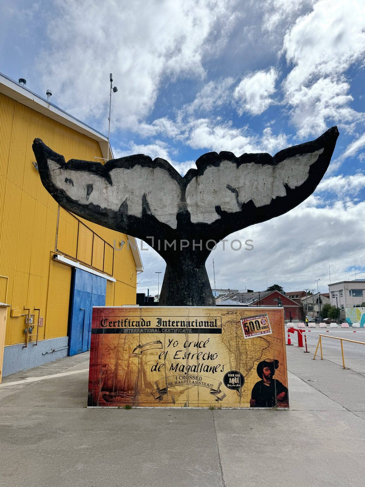 Punta Arenas, Chile 10.22.2023 A large whale tail monument with a decorative sign commemorates travelers who crossed the Strait of Magellan, celebrating 500 years of the historic route.