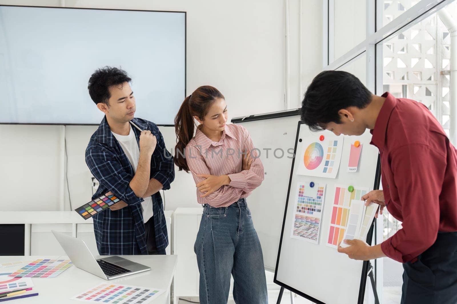 Creative professionals engage in a vibrant discussion about color options, reflecting on the mood and impact of their choices.