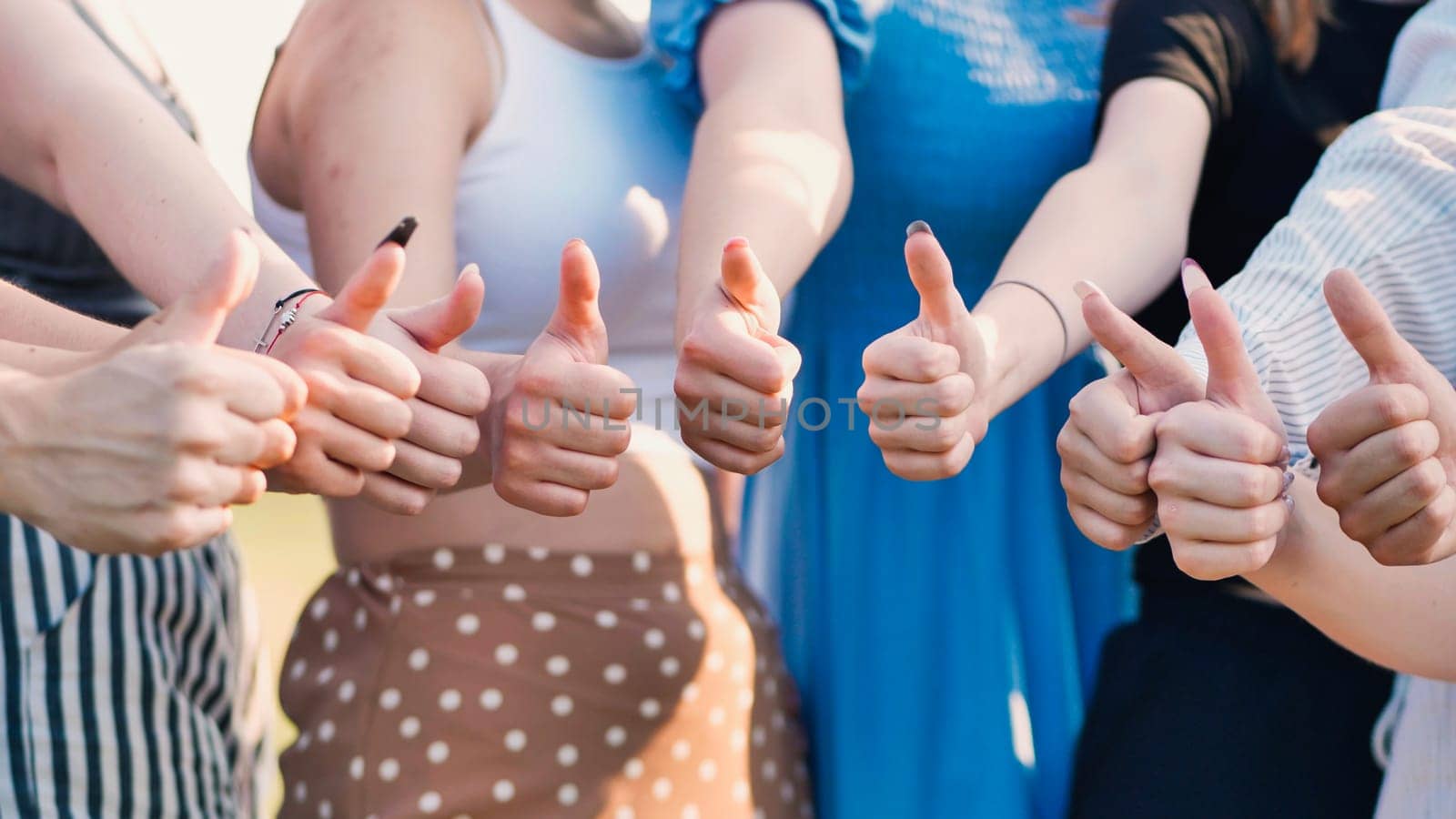 Group of students giving thumbs up, celebrating teamwork, agreement, and shared success, radiating positivity and confidence together