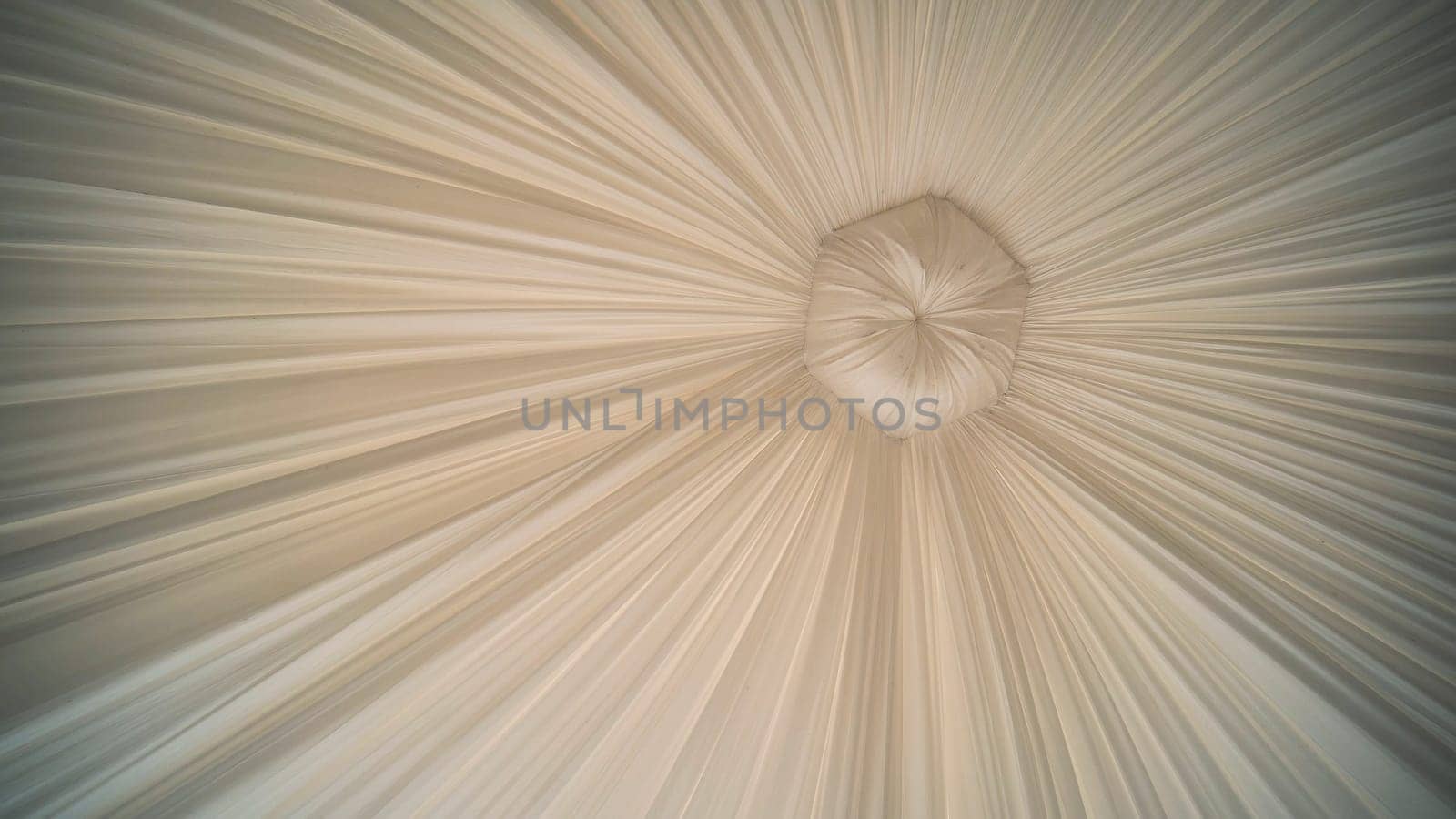 Ethereal white fabric cascading from central anchor, forming graceful swirls suggesting romantic wedding design element