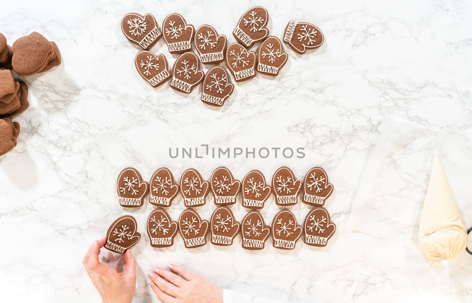 Rows of both decorated and plain mitten cookies are arranged together, highlighting the transition from unadorned to beautifully iced holiday cookies.