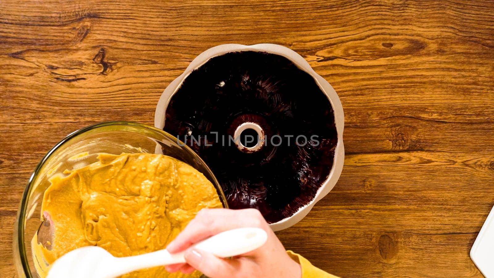 Flat lay. Pouring the gingerbread cake batter into the greased bundt cake pan, ready for a delightful caramel frosting.
