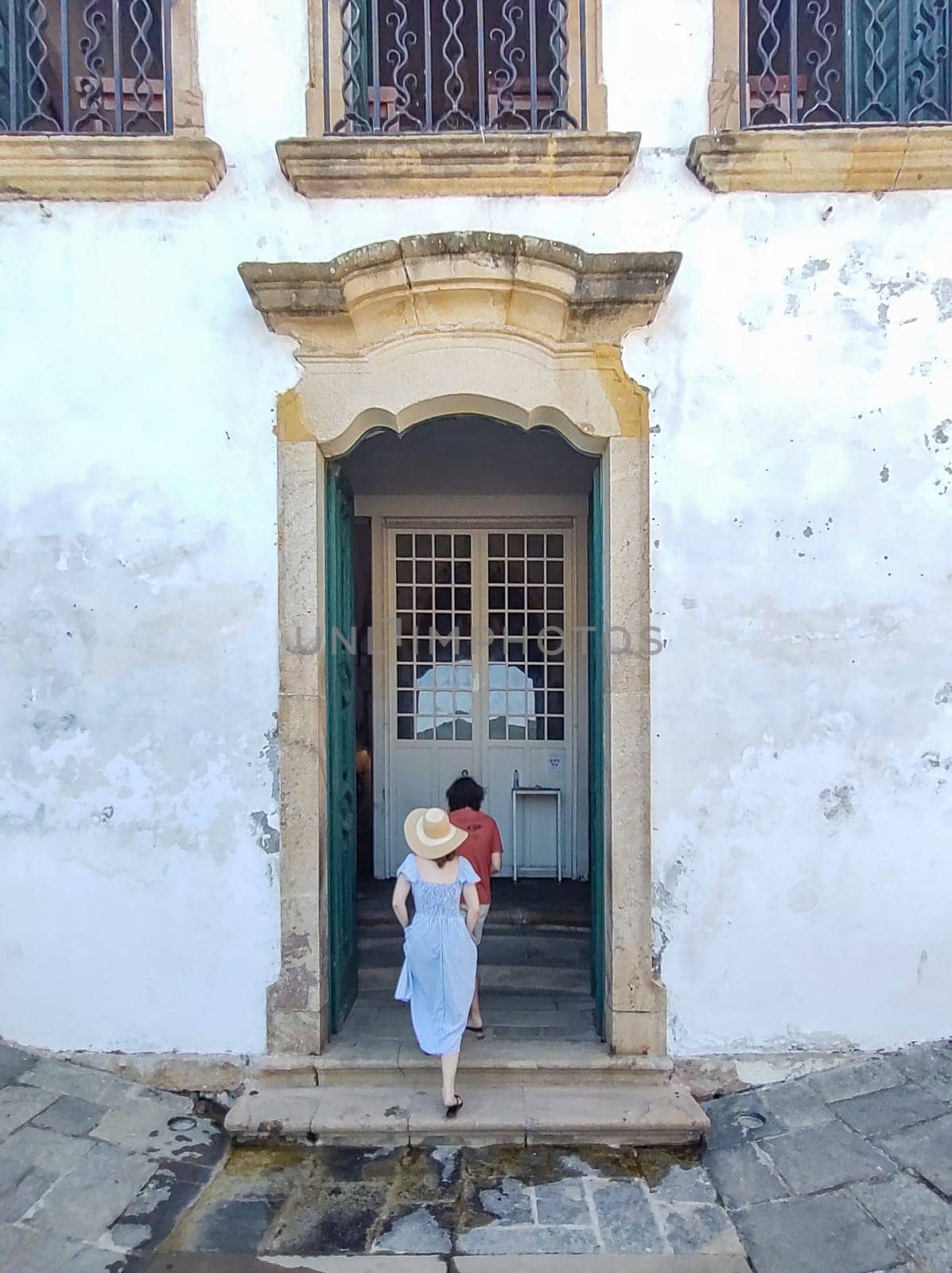 Paraty, Rio de Janeiro, Brazil, February 6, 2025, tourist couple entering the colonial portal of the Church of Santa Rita.