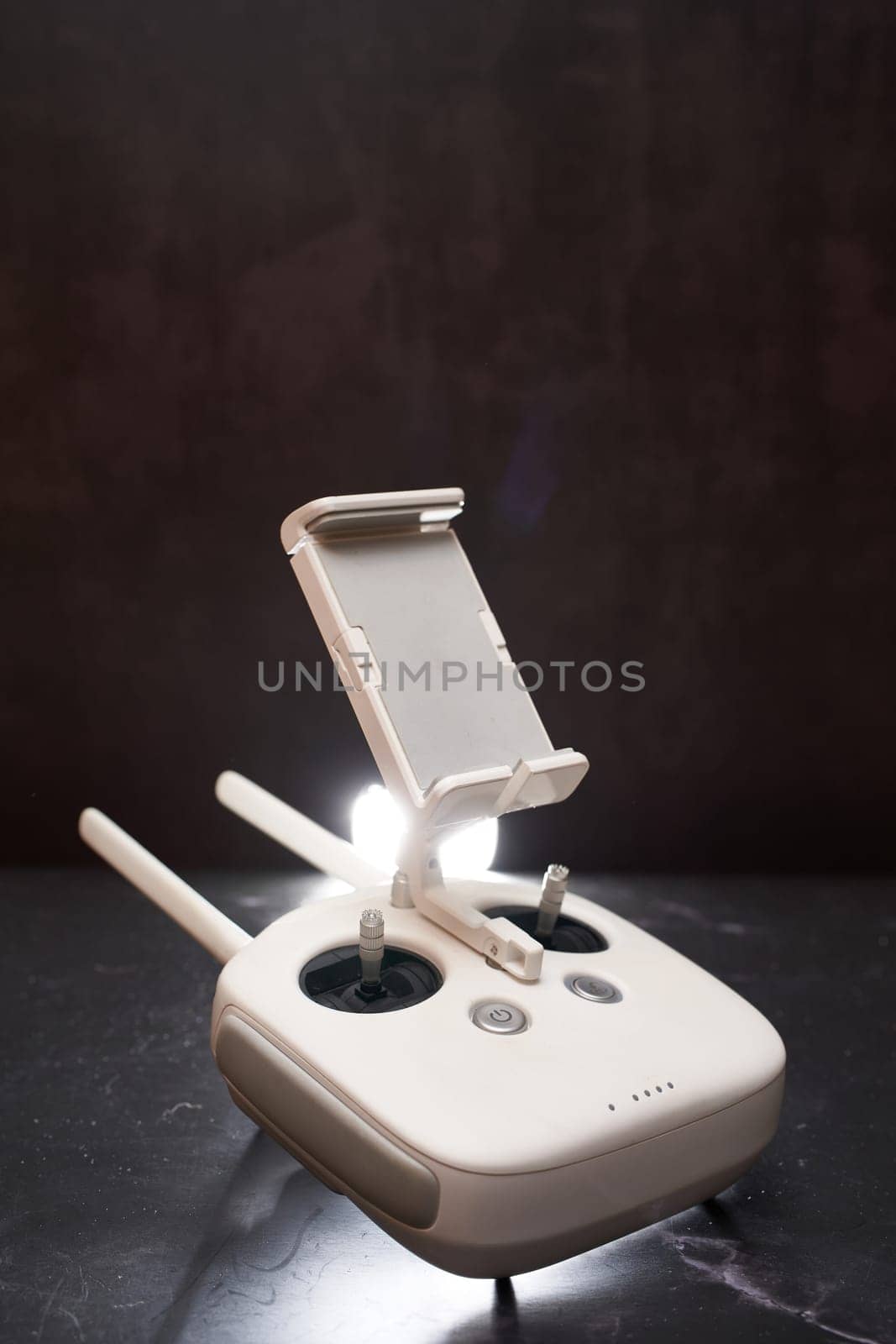 DJI Phantom Professional drone remote control stands on a black table. High quality photo