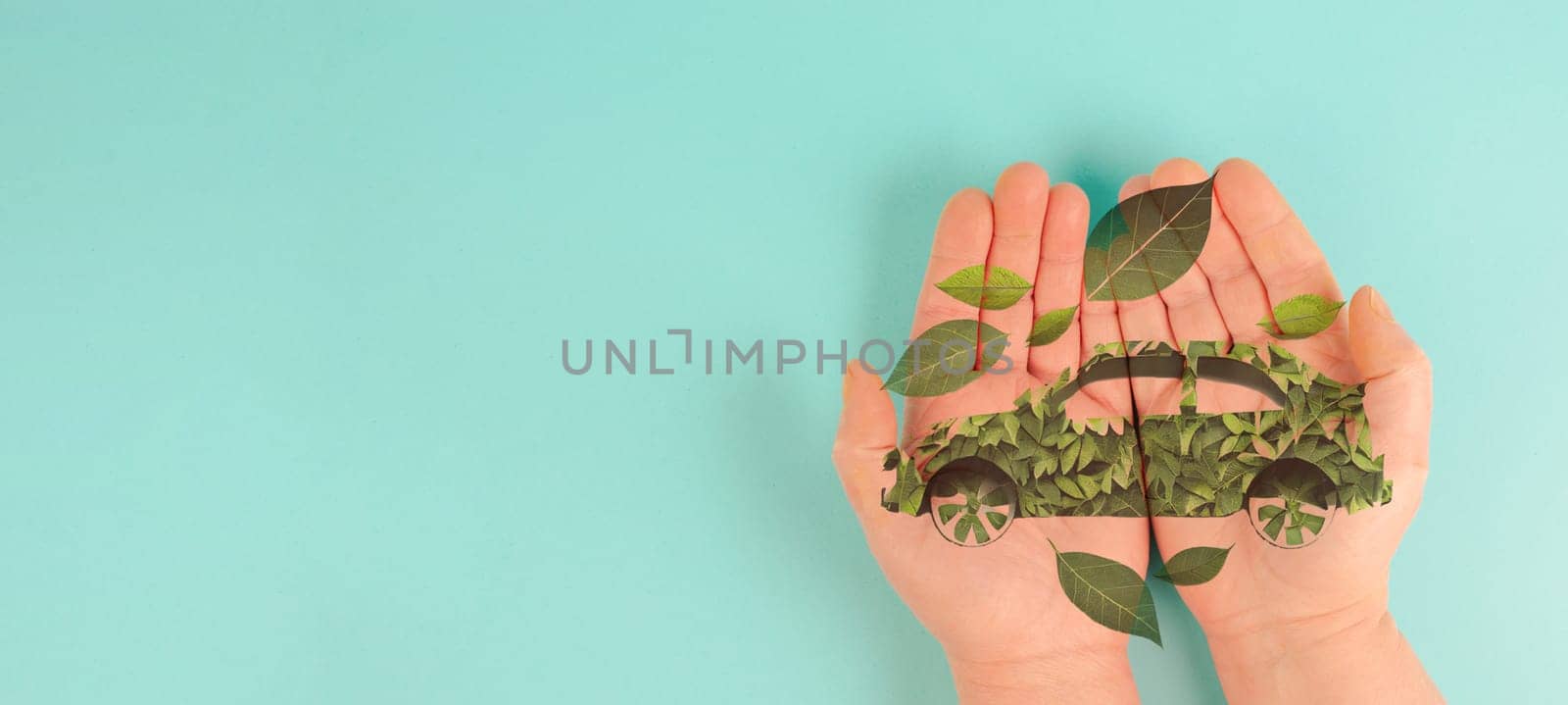 Holding a green electric car made from leaves, sustainable and renewable ressources, eco power, environment issue, generative AI used for the car
