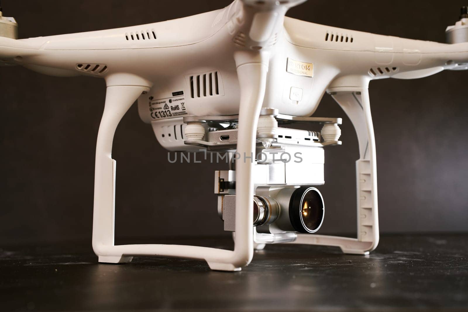 Digital PTZ camera on a white DJI Phantom 3 drone standing on a black table. High quality photo