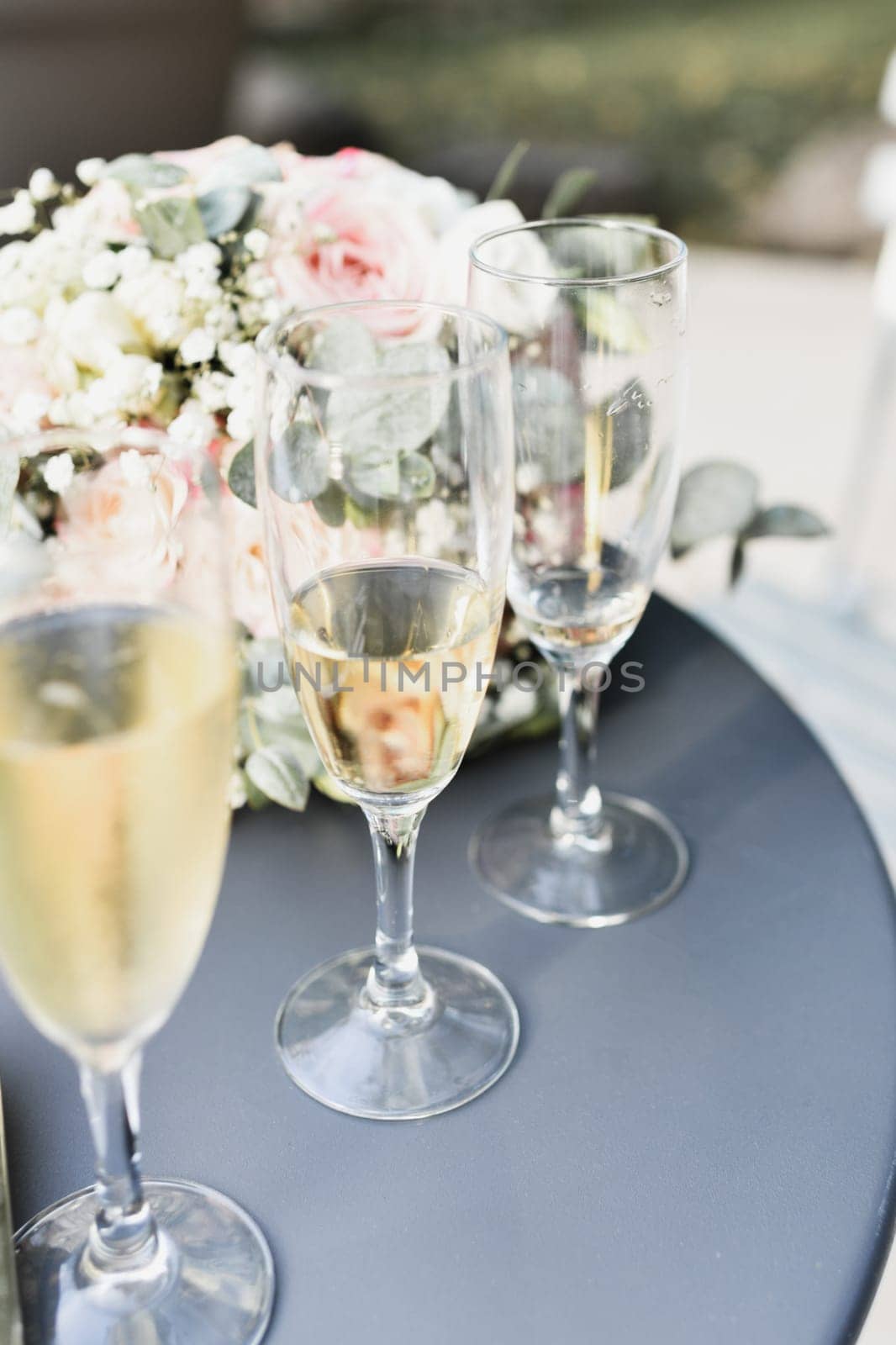 Glasses of champagne and bouquet on a wedding