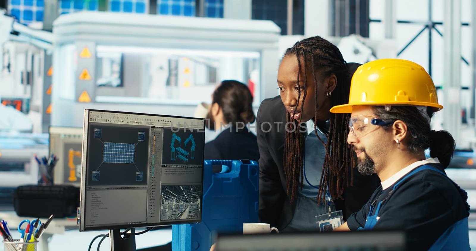 Solar panels plant expert instructing technician how to best harness sun power. Photovoltaics factory african american researcher shows worker how to improve efficiency, camera B