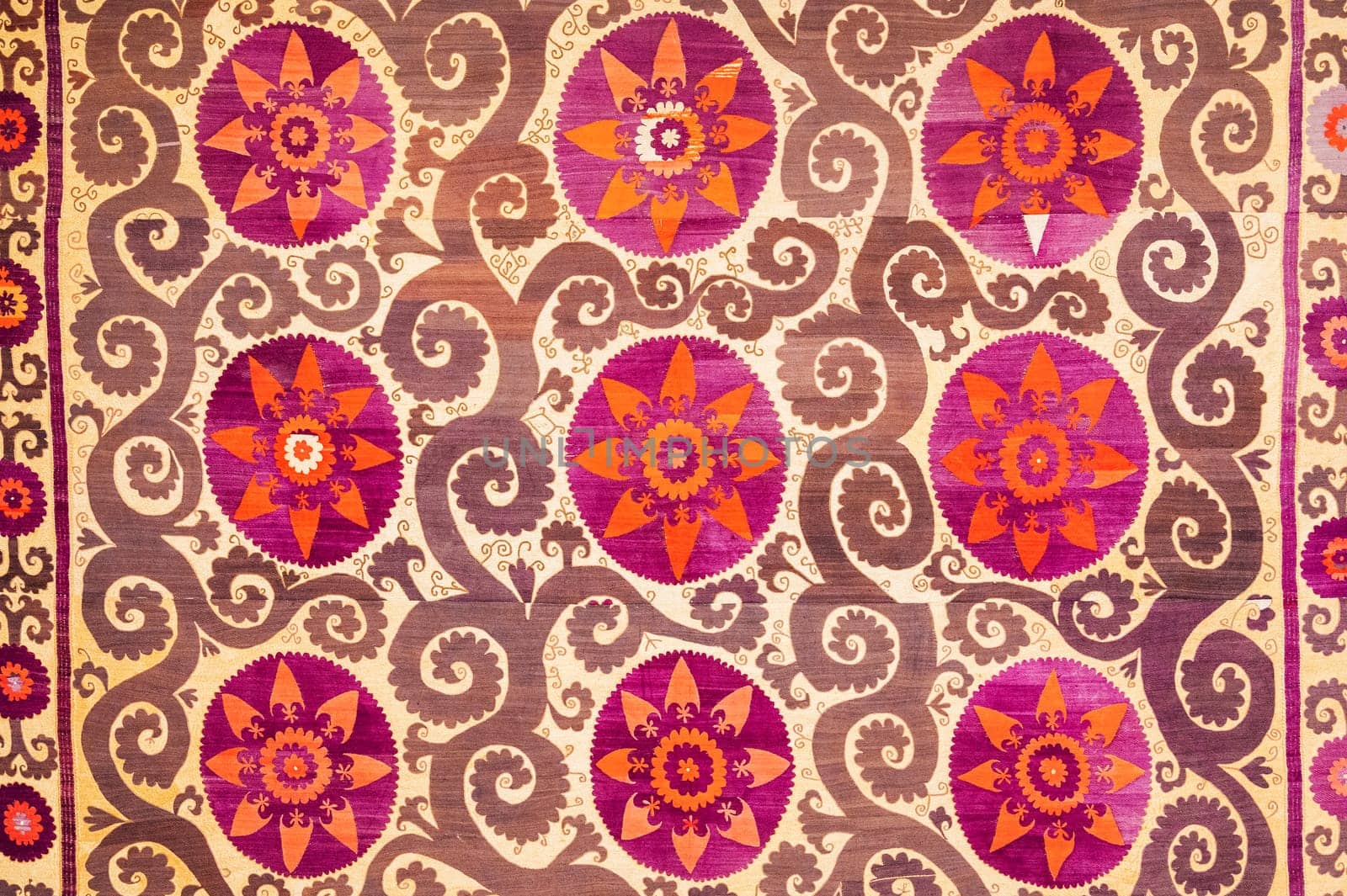 traditional Uzbek pattern on an ancient handmade carpet in Uzbekistan. Oriental background with beautiful ornaments