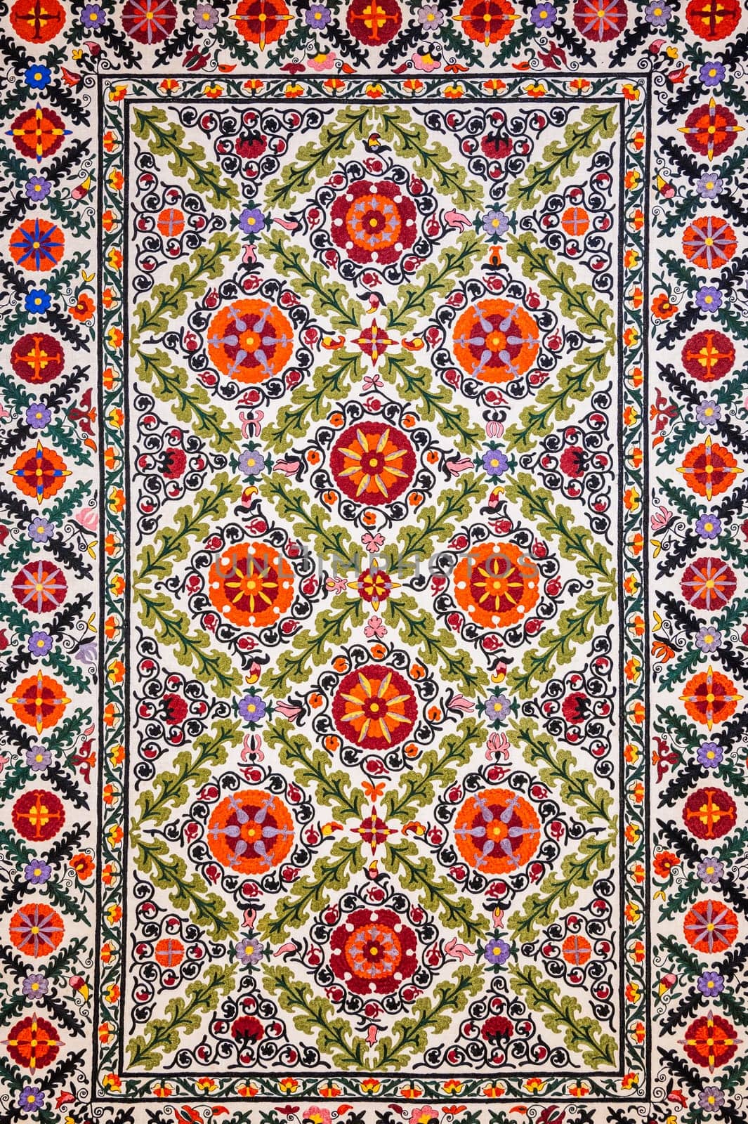 traditional Uzbek geometric pattern on an ancient handmade carpet in Uzbekistan. Oriental background with beautiful ornaments